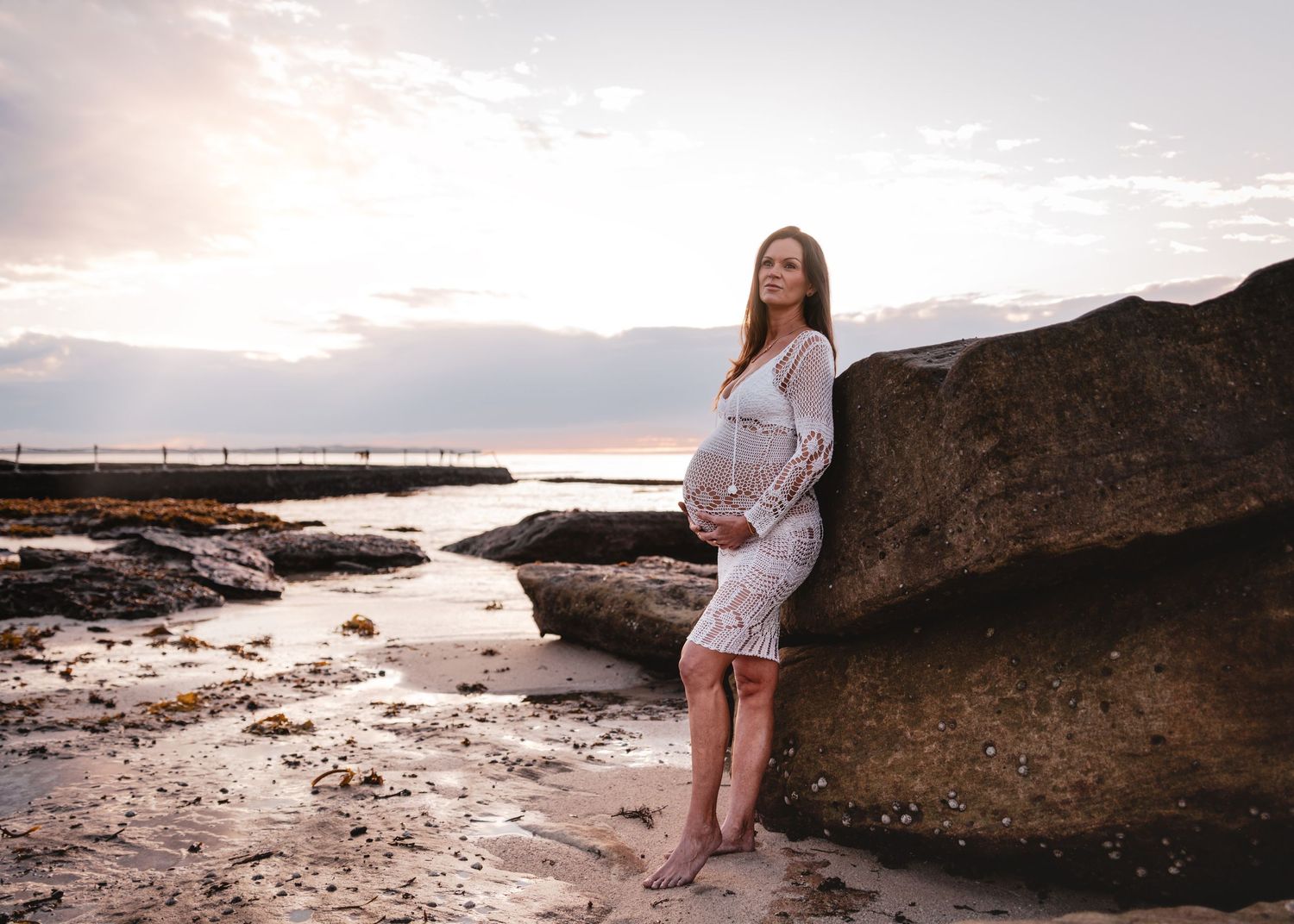 A scenic coastal photo series featuring rocky cliffs and beach views at sunset with dramatic lighting.