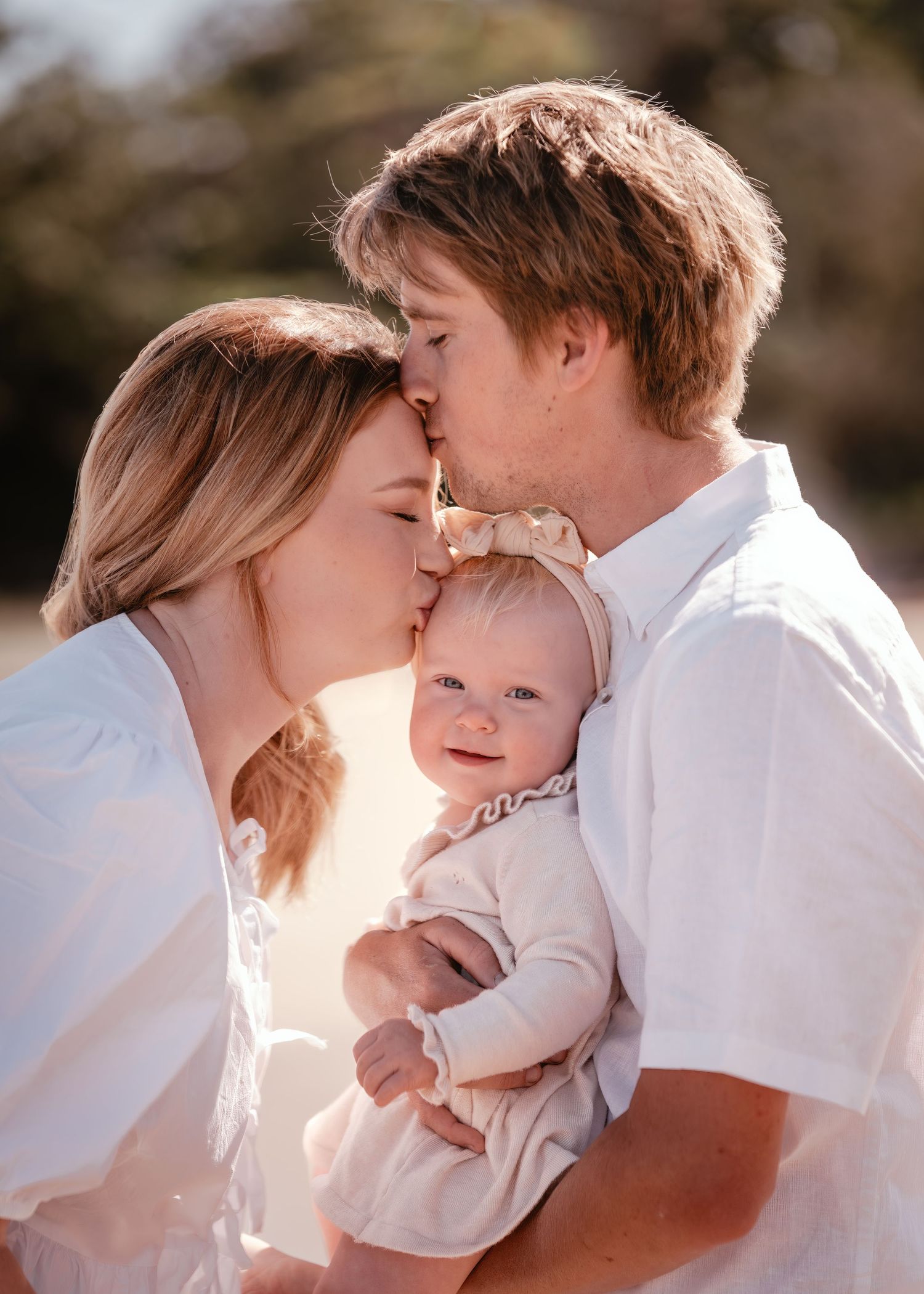 A series of intimate family photos showing tender moments between parents and their baby in soft sunlit lighting.