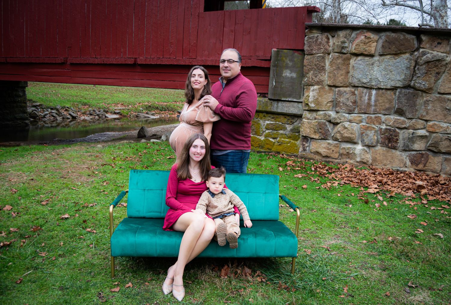 A collection of outdoor family portraits taken on a green bench near a stone wall in autumn.