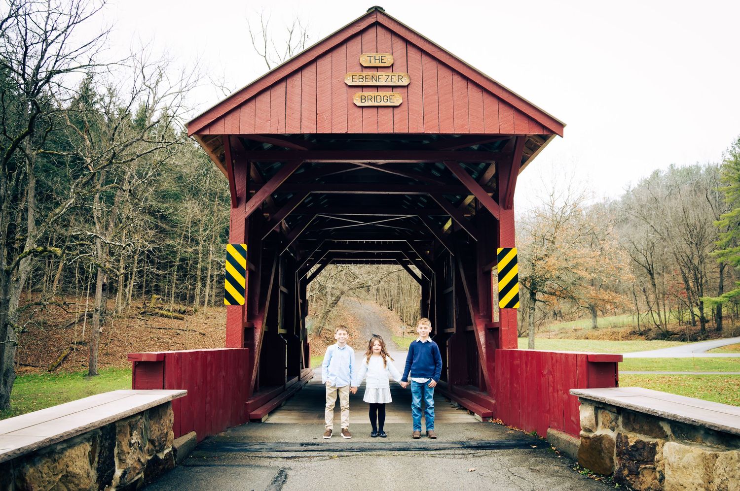 A collection of five red covered bridges in rural settings showing different architectural styles and scenic surroundings.