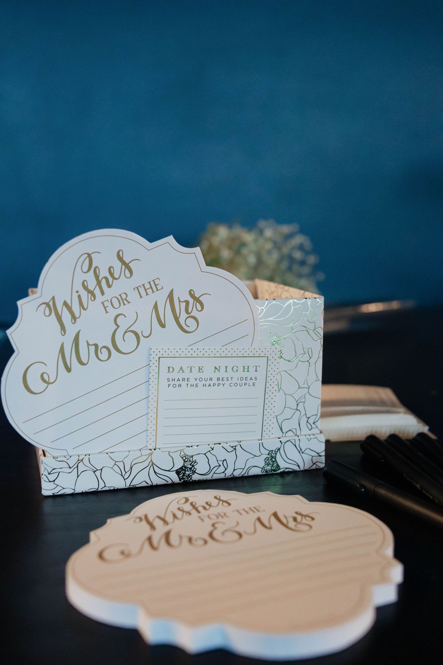 Elegant wedding wishes box for Mr. and Mrs. with date night cards and gold calligraphy on blue background.