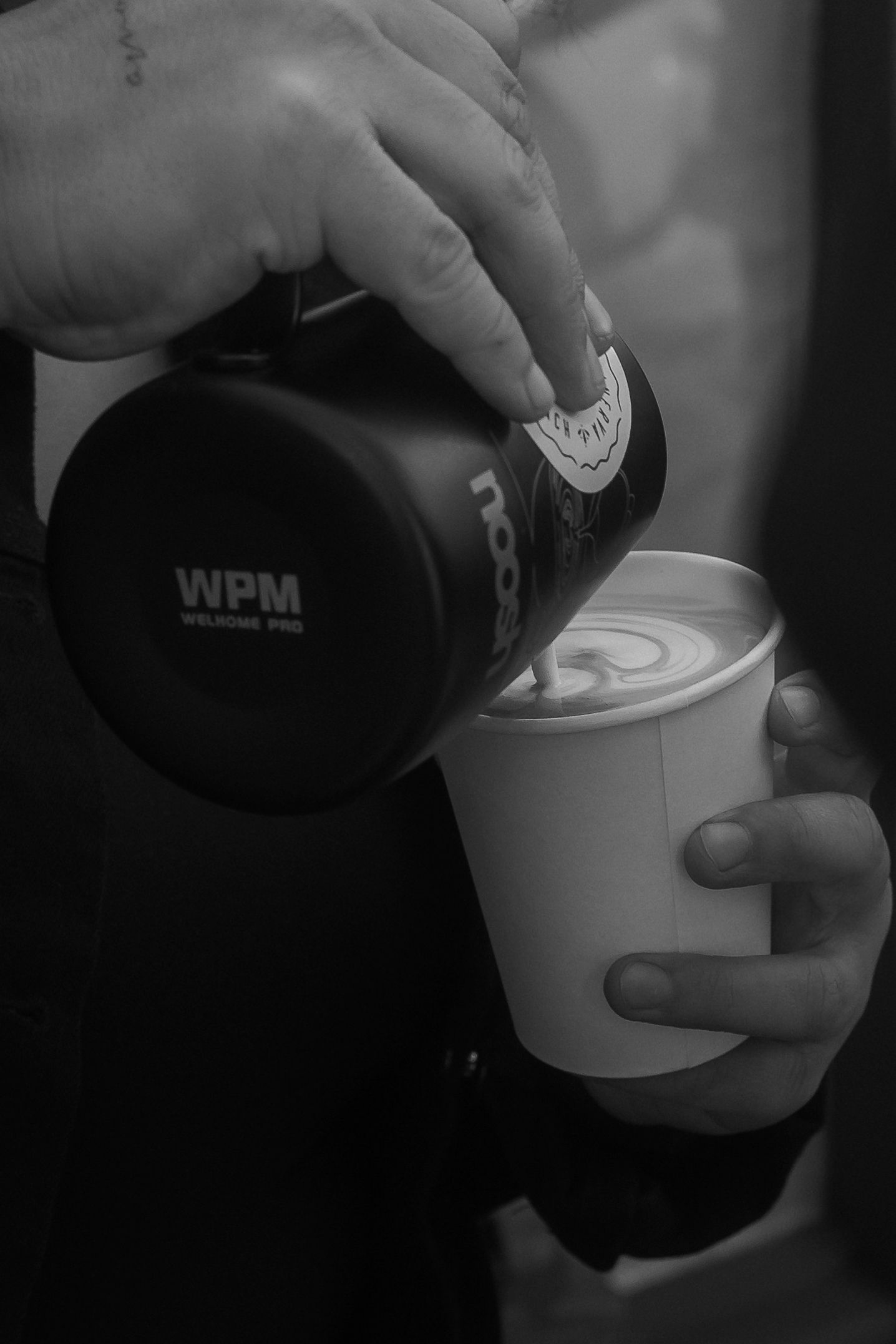A series of black and white photos showing hands preparing coffee or espresso with a white ceramic cup.