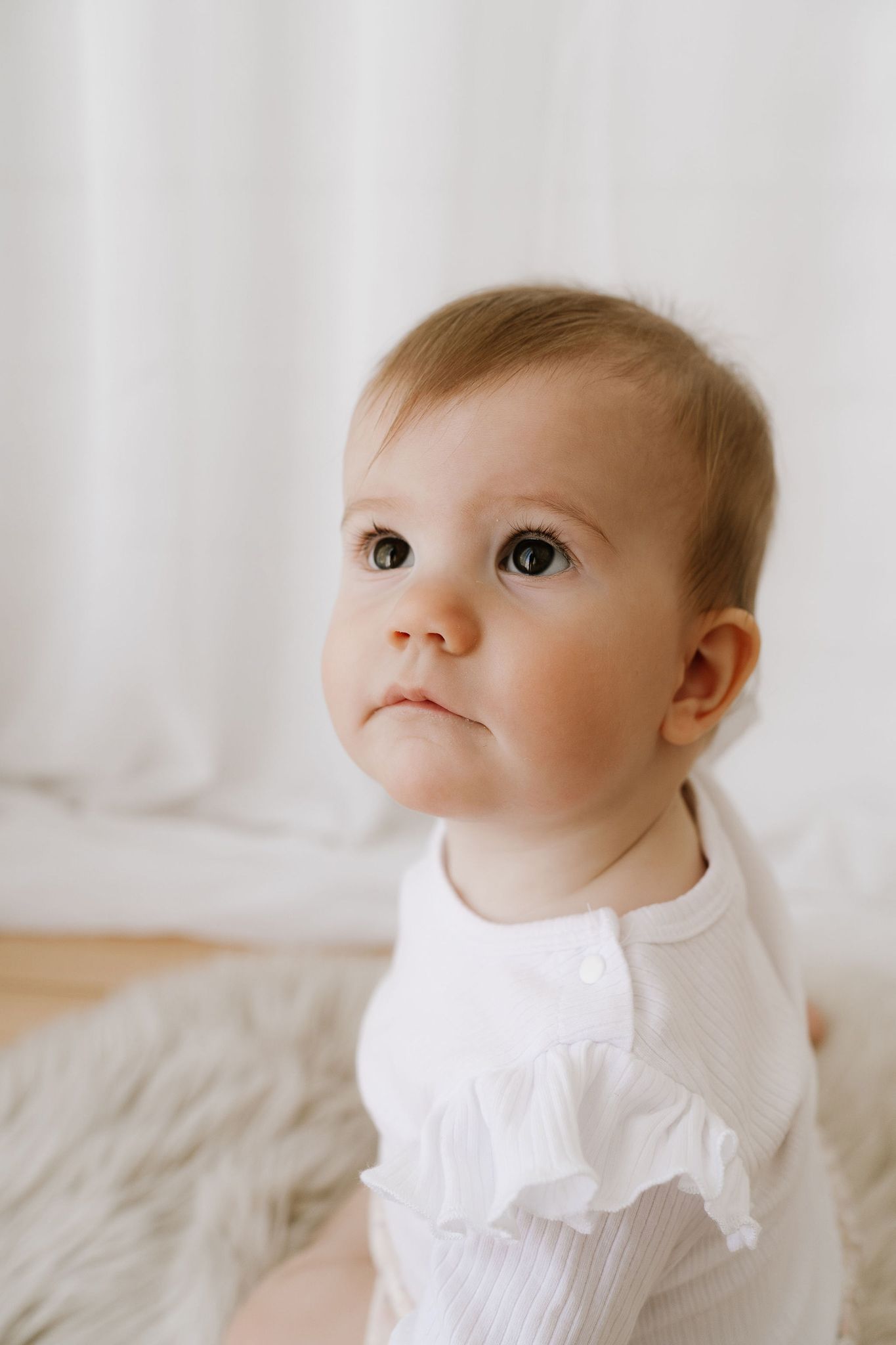 cute baby looking up in studio portrait
