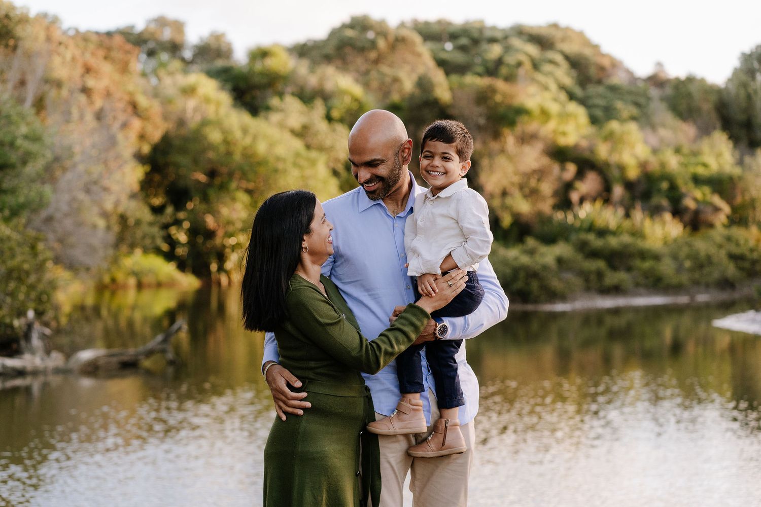 Family outdoor session with young children, capturing playful and tender moments in a softly lit, minimal setting.