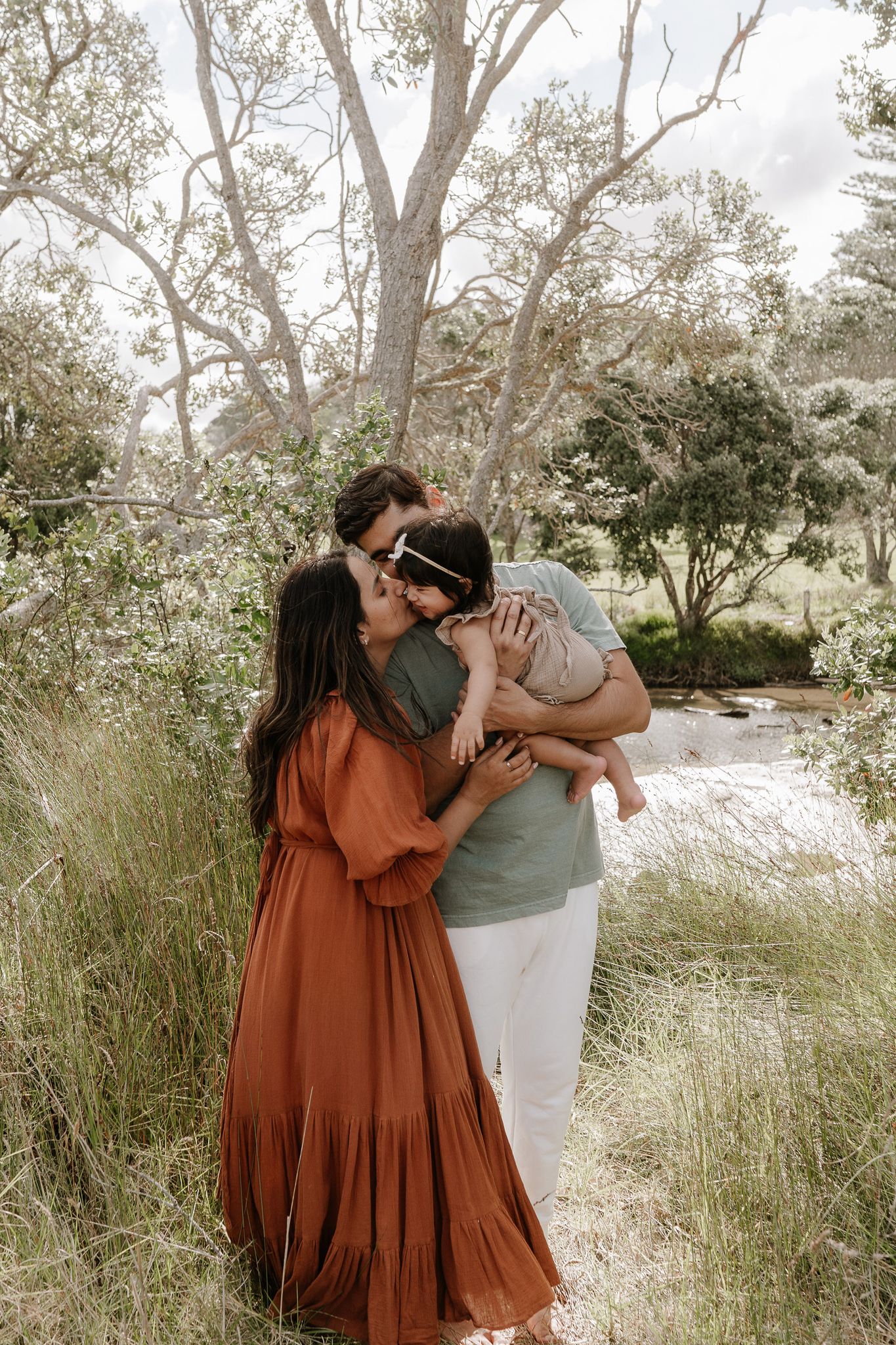 Family outdoor session with young children, capturing playful and tender moments in a softly lit, minimal setting.
