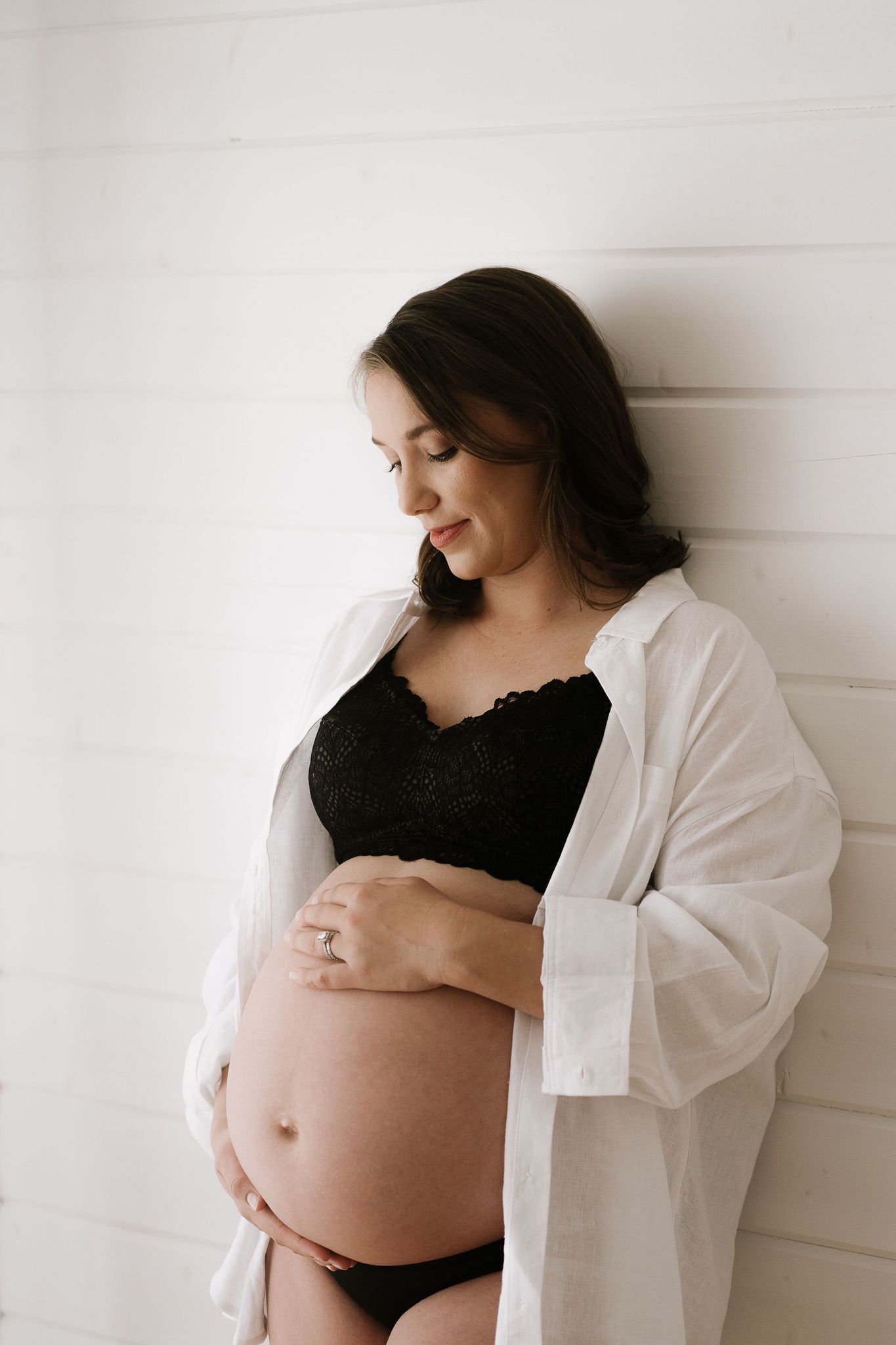mum looking at baby belly in neutral studio