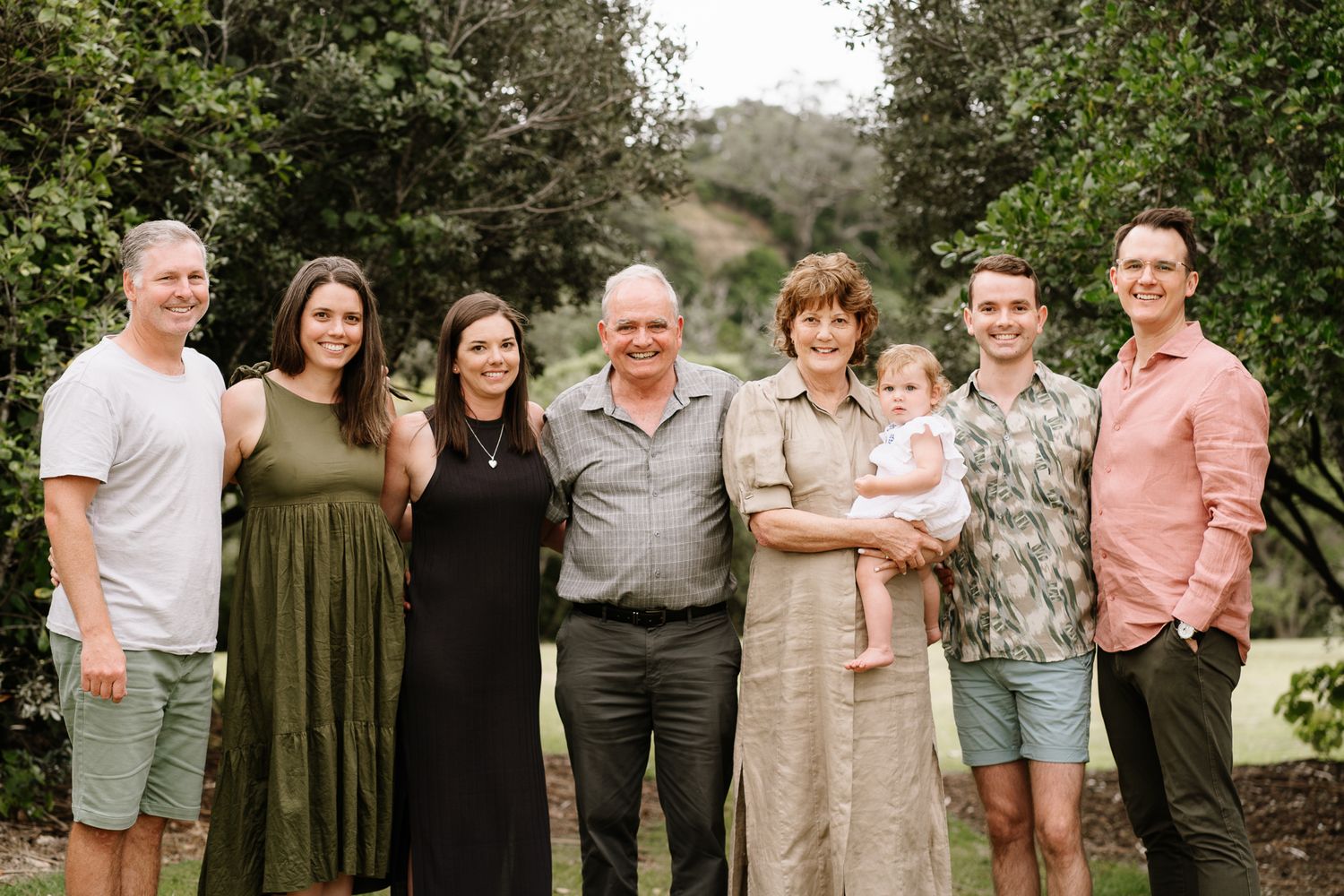 Family portrait session featuring parents and their older children sharing laughter and connection. A mix of posed and candid shots in a nat