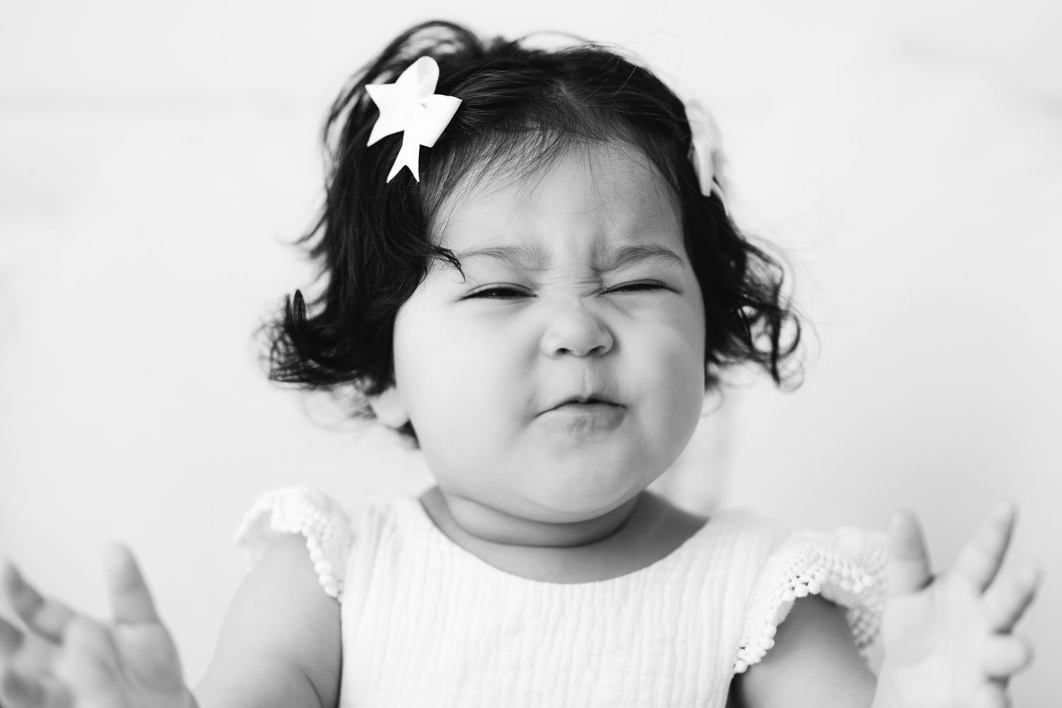 cute baby scrunching up face in studio portrait