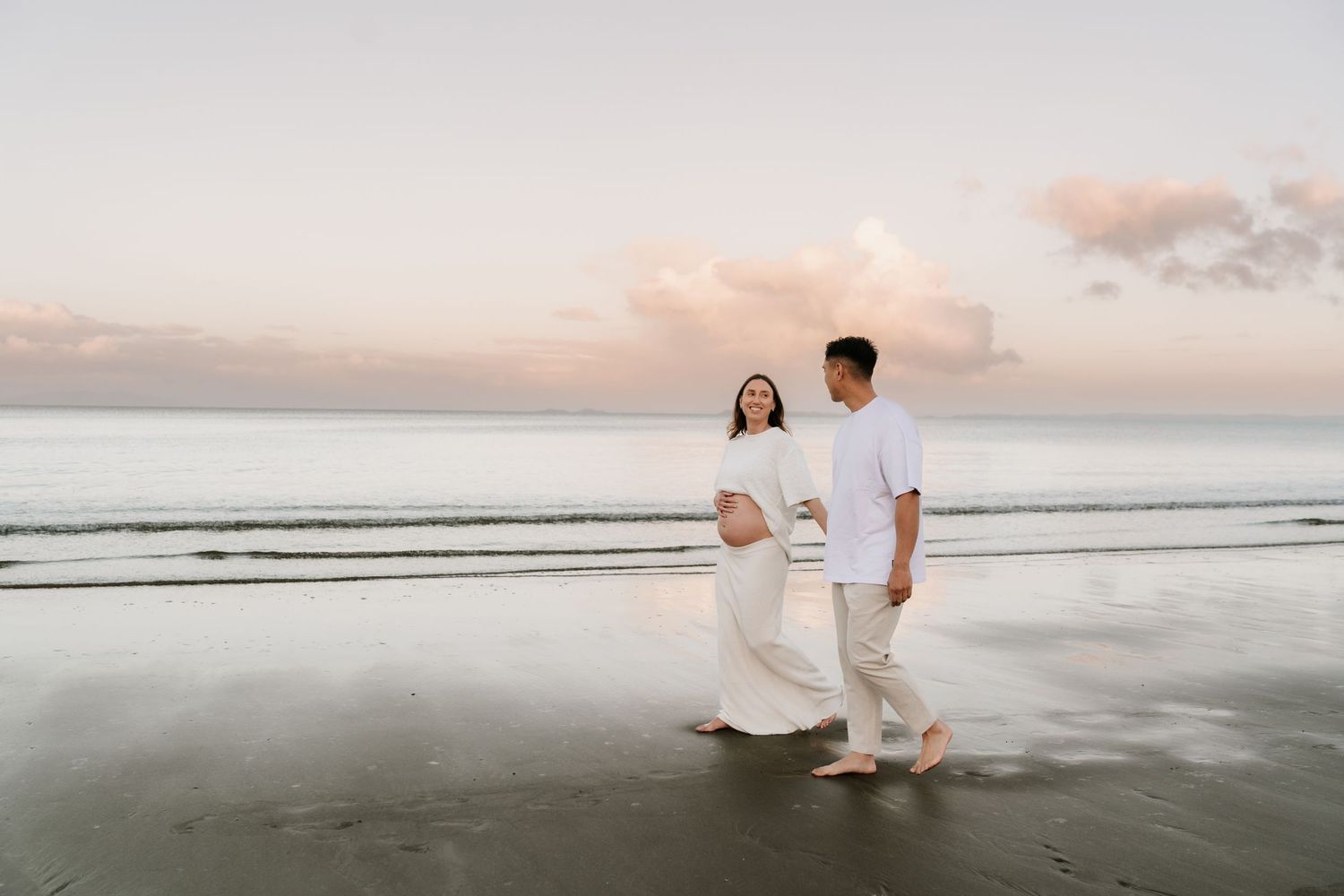 Earthy and organic maternity session at a North Shore beach. Capturing the golden hour glow in Auckland with Little Wild Ones.