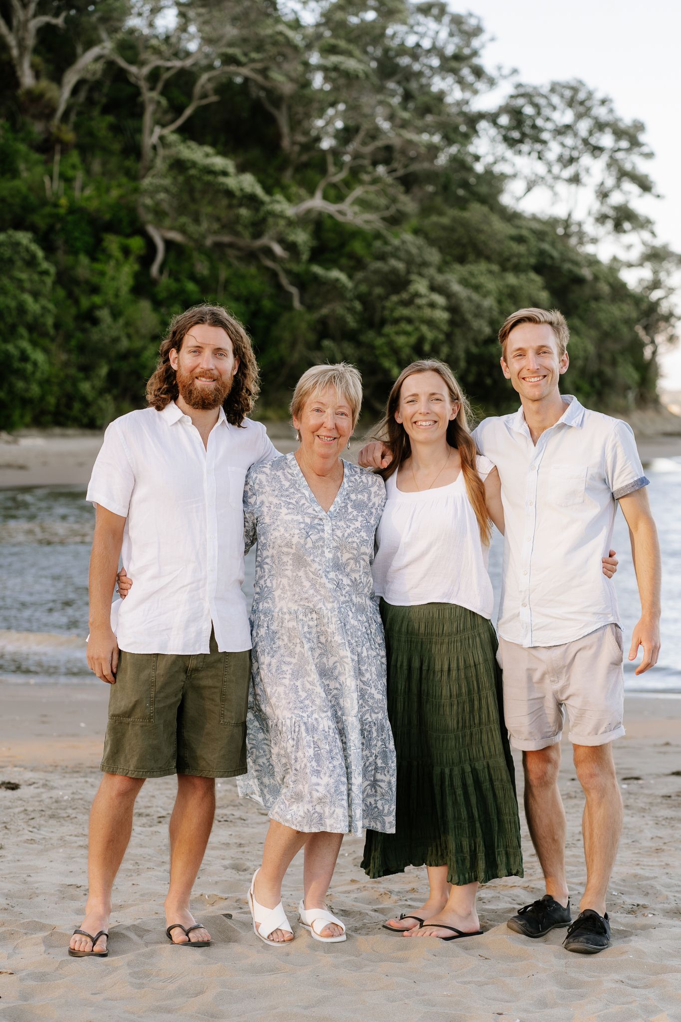 Family portrait session featuring parents and their older children sharing laughter and connection. A mix of posed and candid shots in a nat