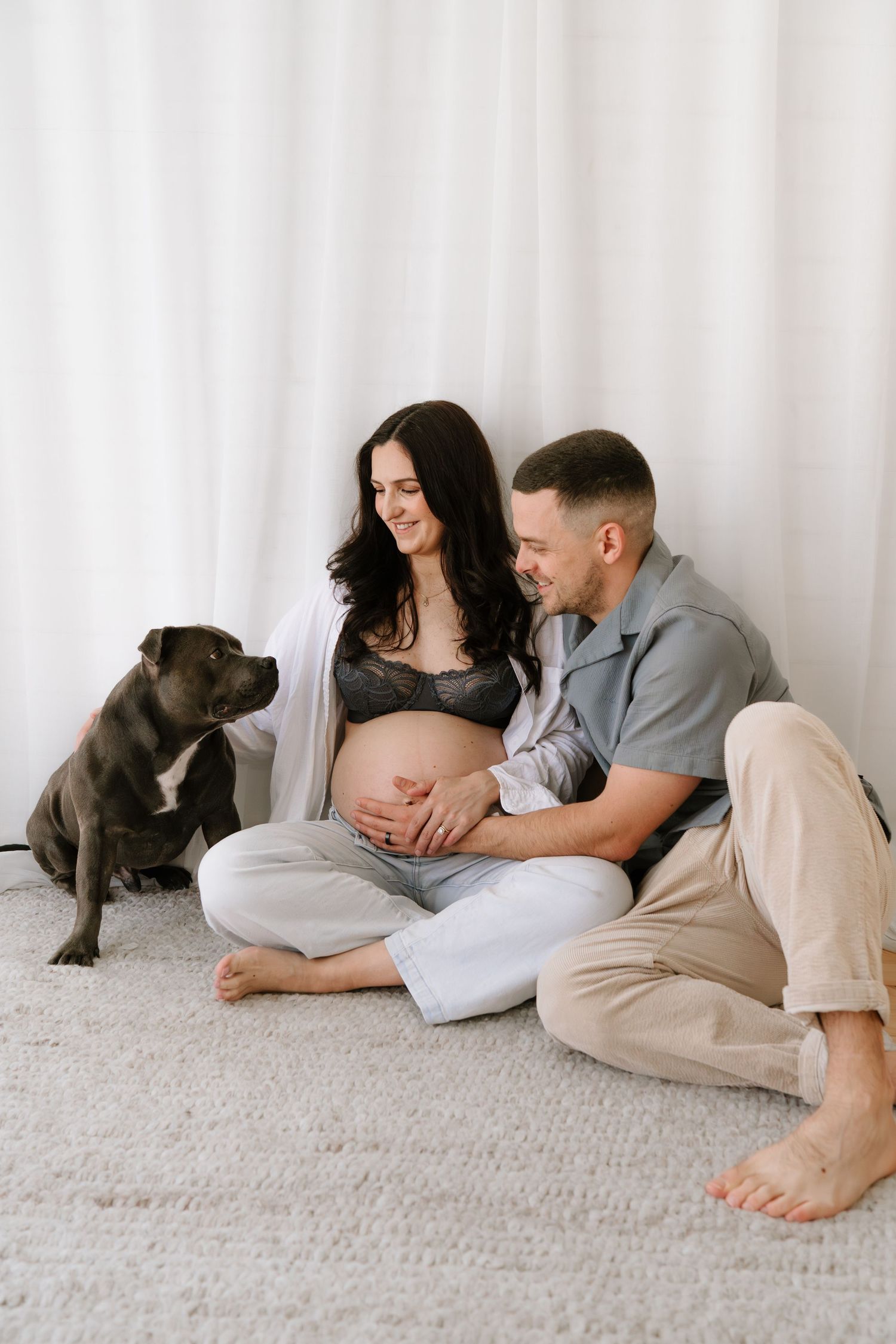Modern family maternity session including the dog. Little Wild Ones captures honest emotion in our minimalist Torbay studio