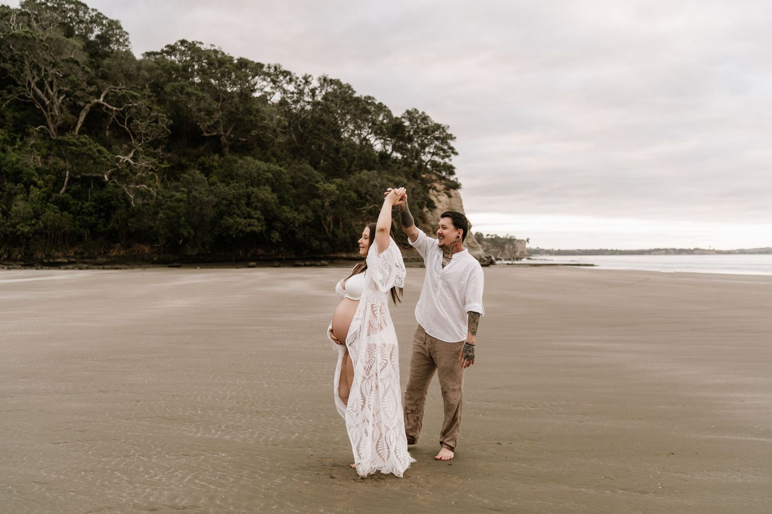 Adventurous sunset maternity session on a rugged North Shore beach. Little Wild Ones captures honest, emotive moments.