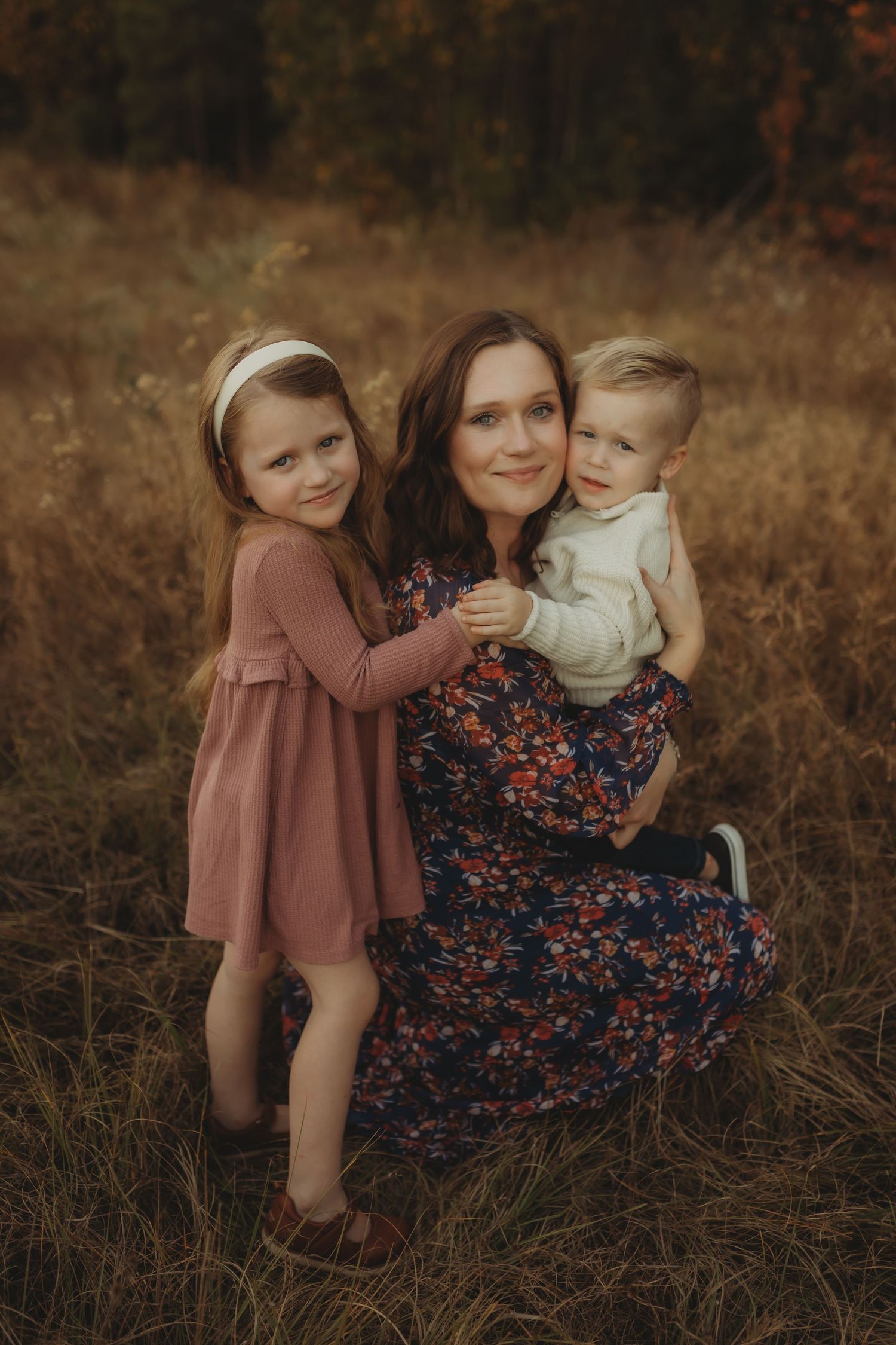A heartwarming outdoor family photo session in autumn with warm earth tones and natural lighting.