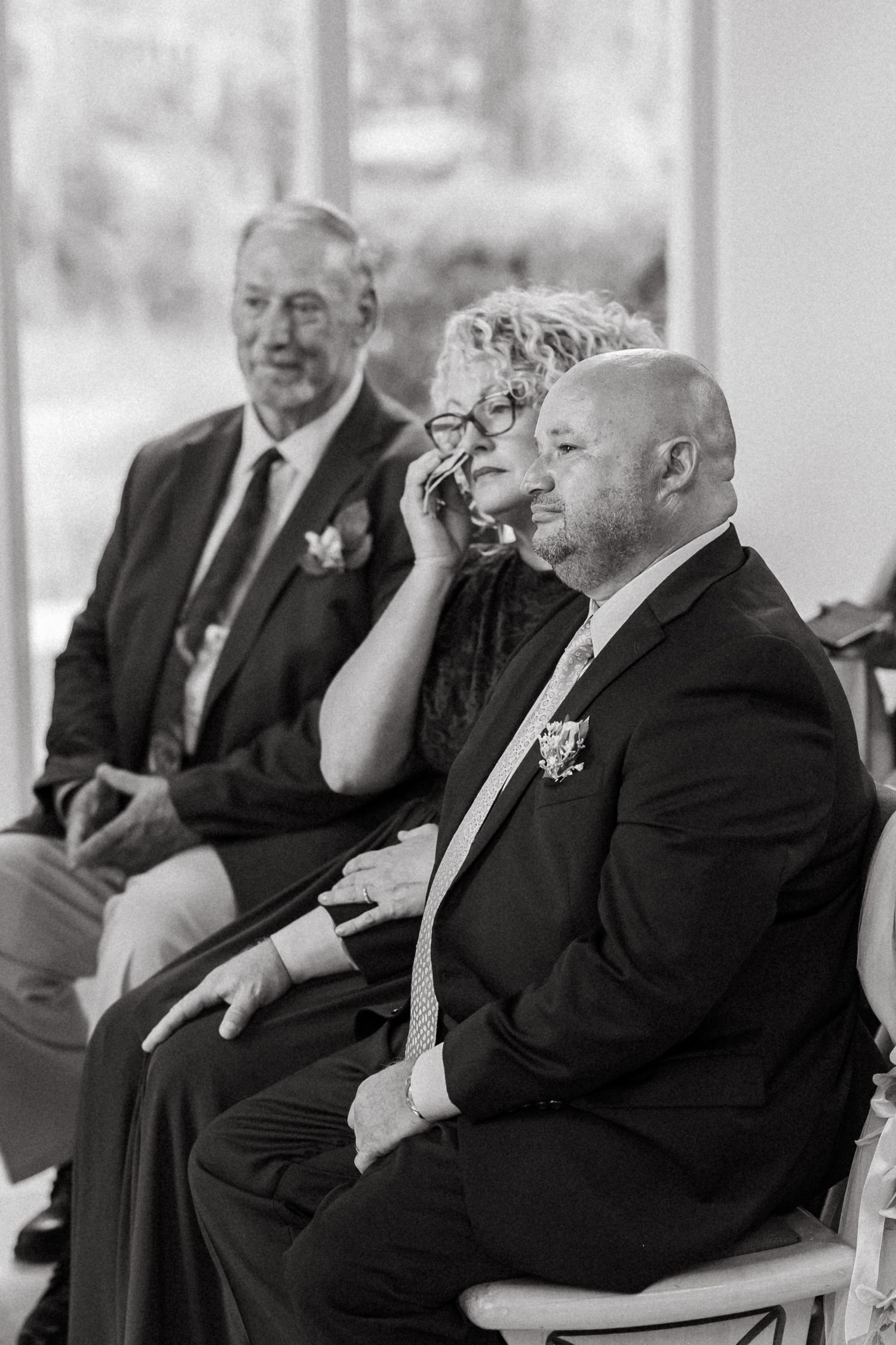 Emotional black and white candid of wedding guests during a Florida wedding ceremony.