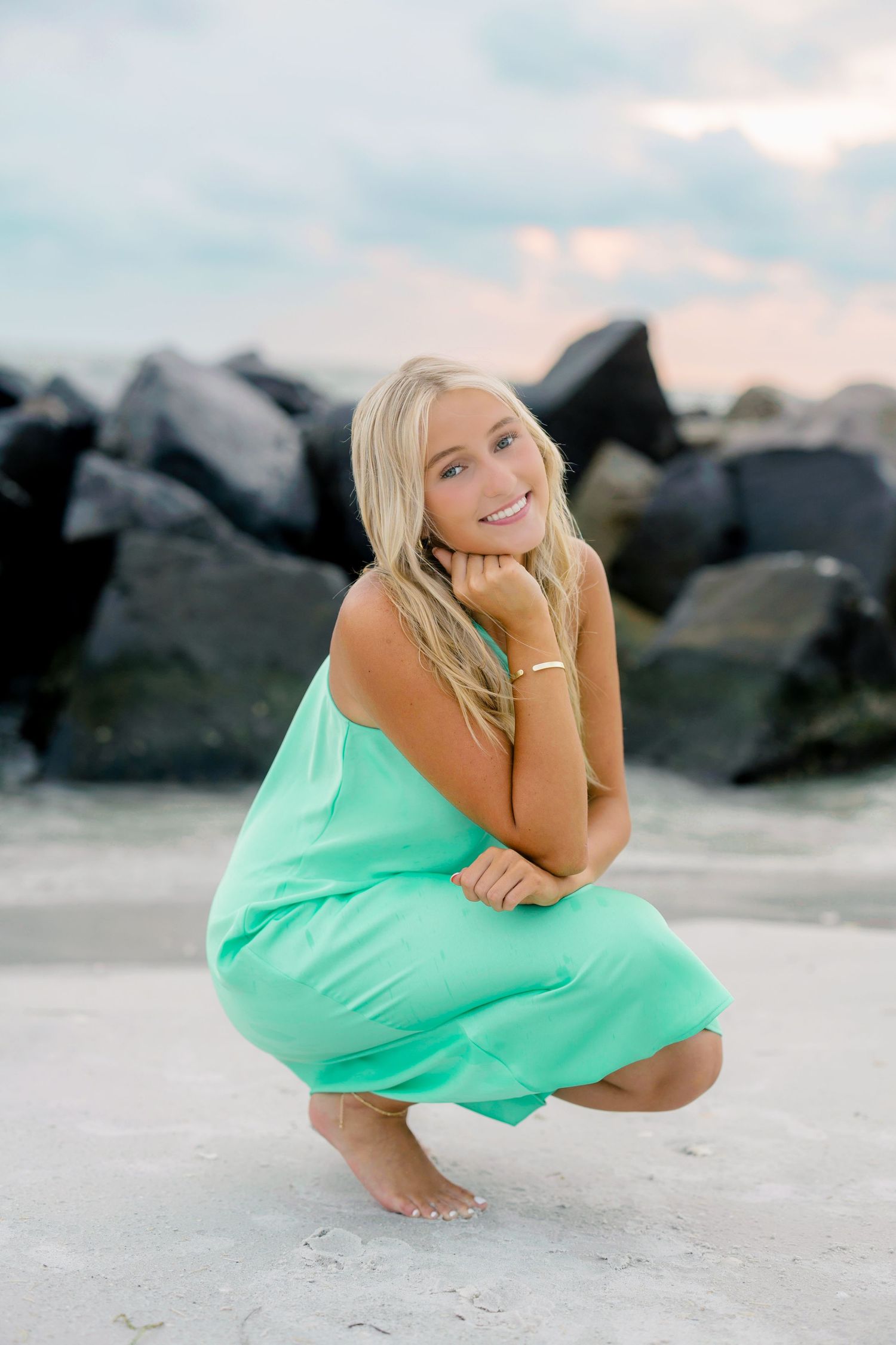 Senior portrait in mint green dress on a Florida beach at sunset.