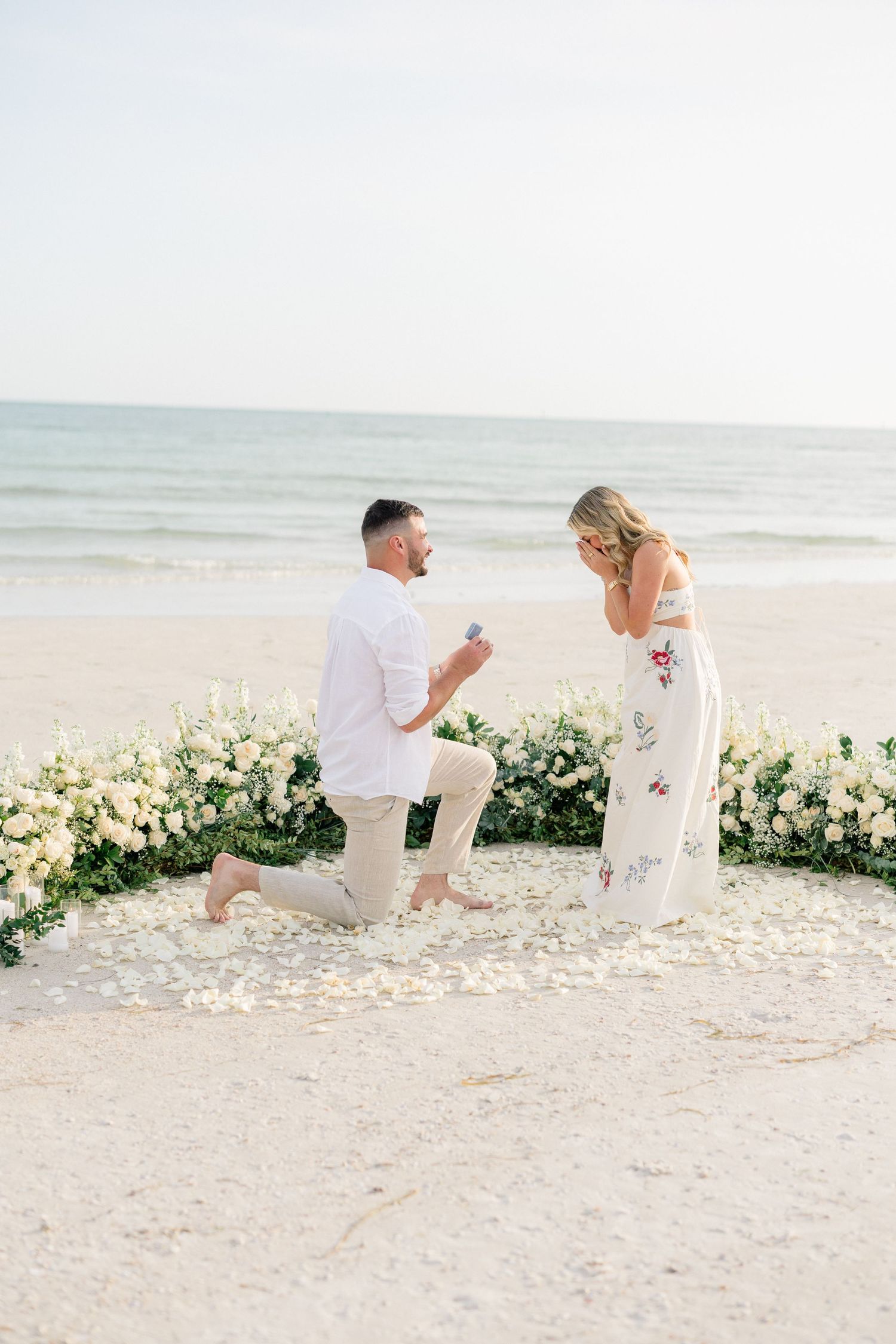 Surprise marriage proposal on St. Pete Beach photographed at sunset in Florida.
