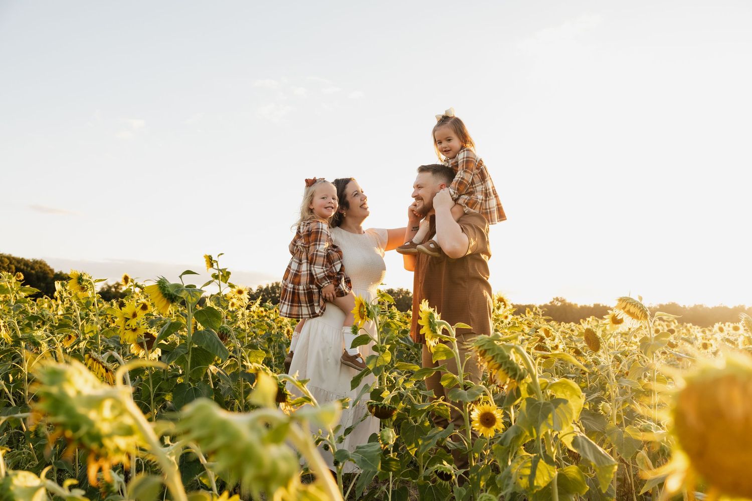 Florida family photography session in a sunflower field at golden hour.