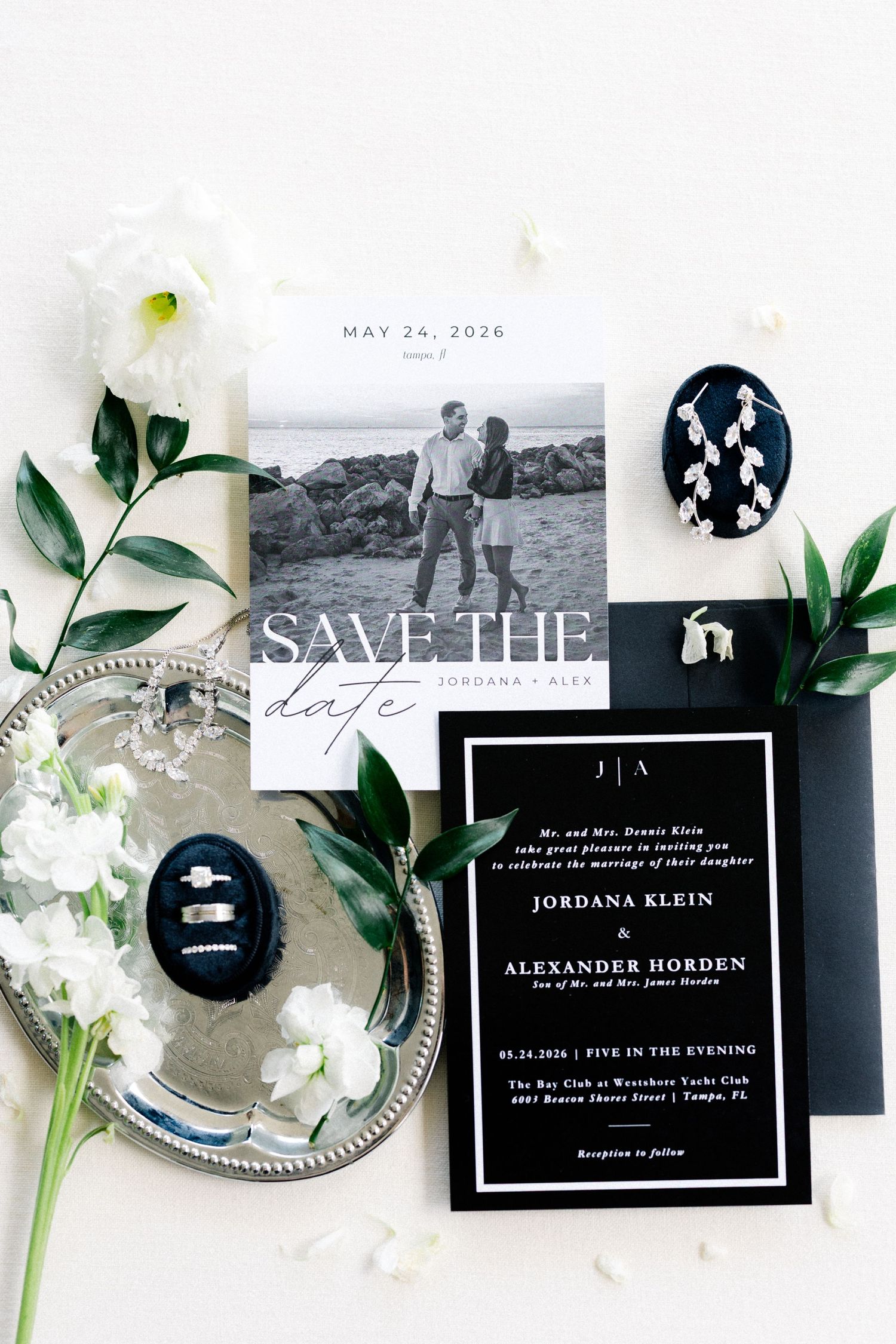 Elegant wedding invitation suite with rings and floral details for a Florida wedding.