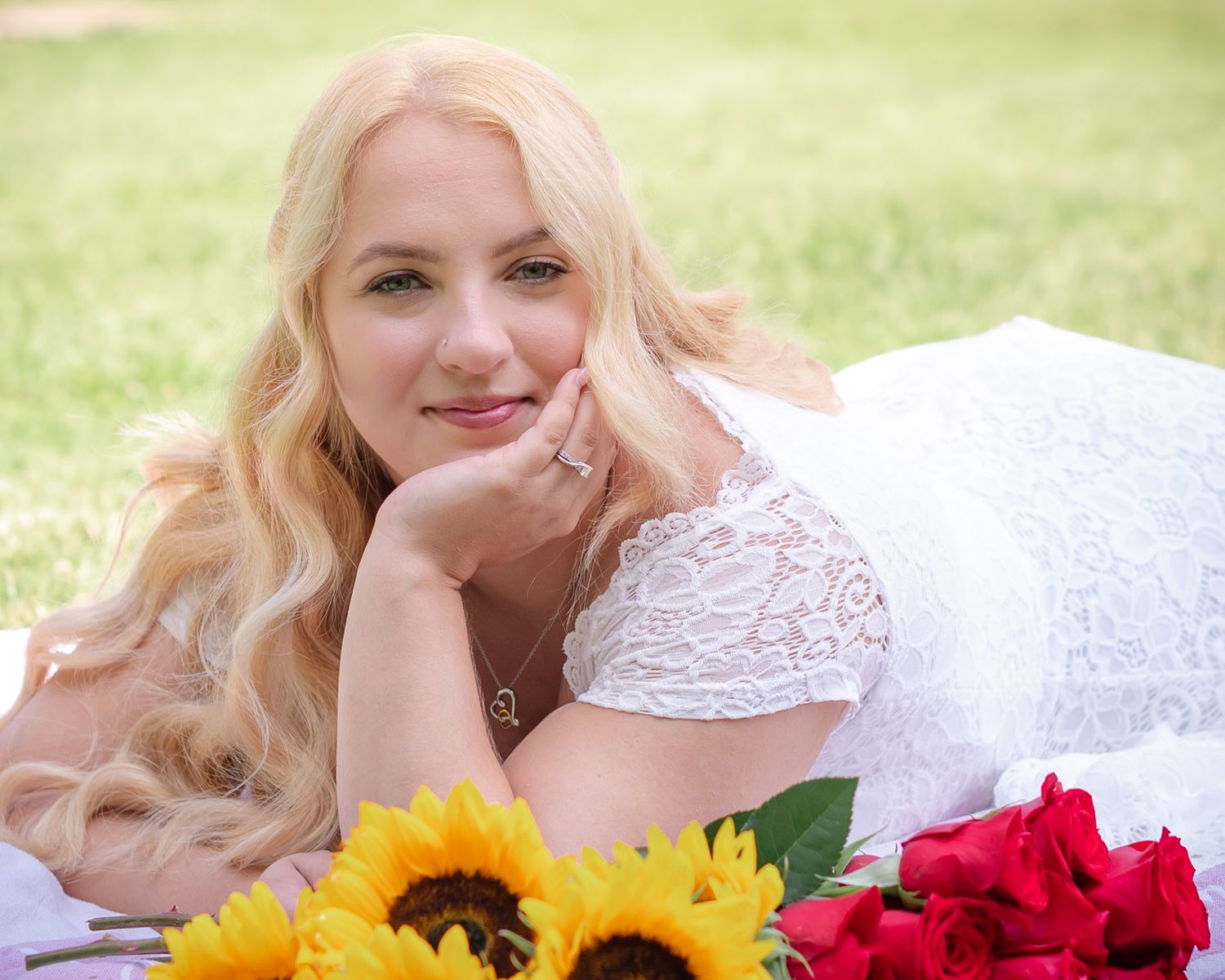 A dreamy bridal portrait with sunflowers and roses against a soft green background.
