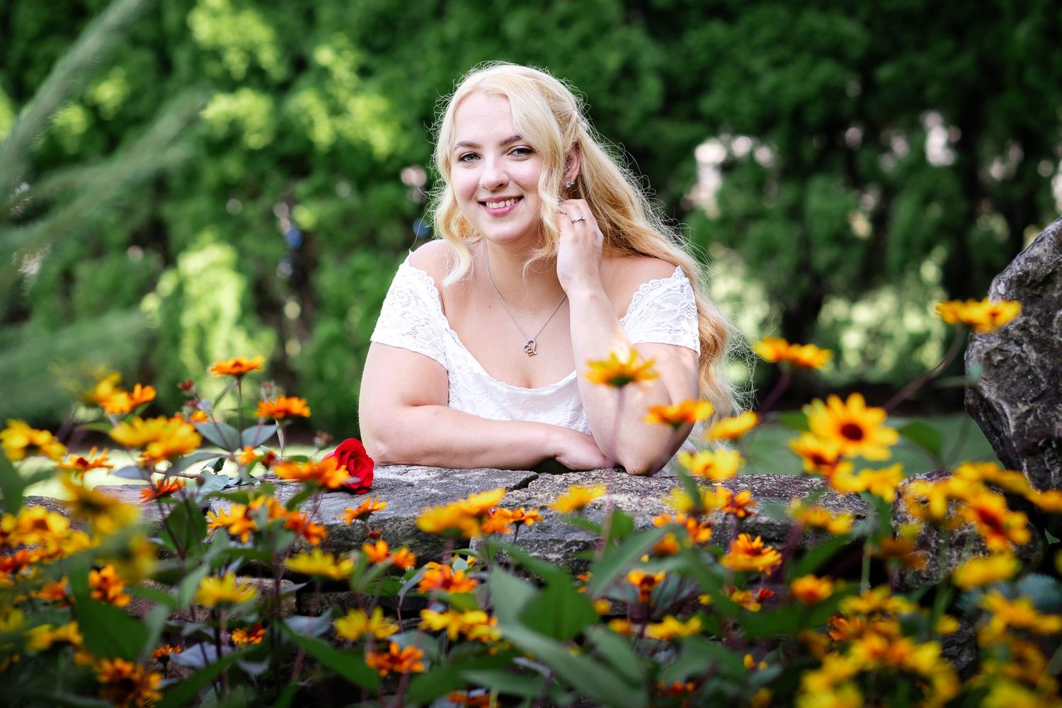 A summer garden bursts with vibrant orange and yellow flowers in full bloom.