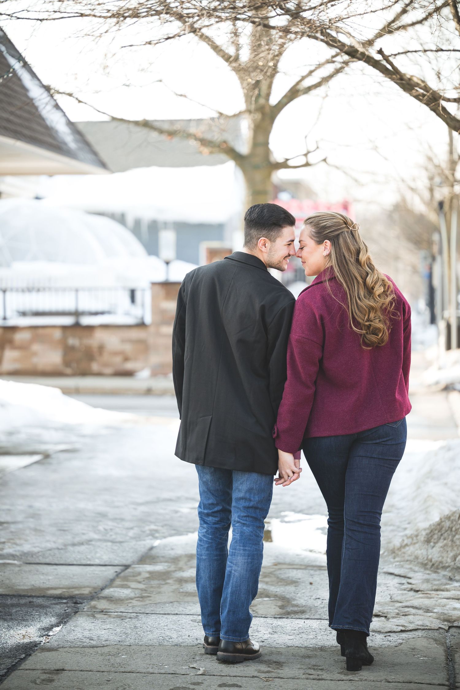 A couple walking together on a winter sidewalk shown from behind in a series of similar shots.