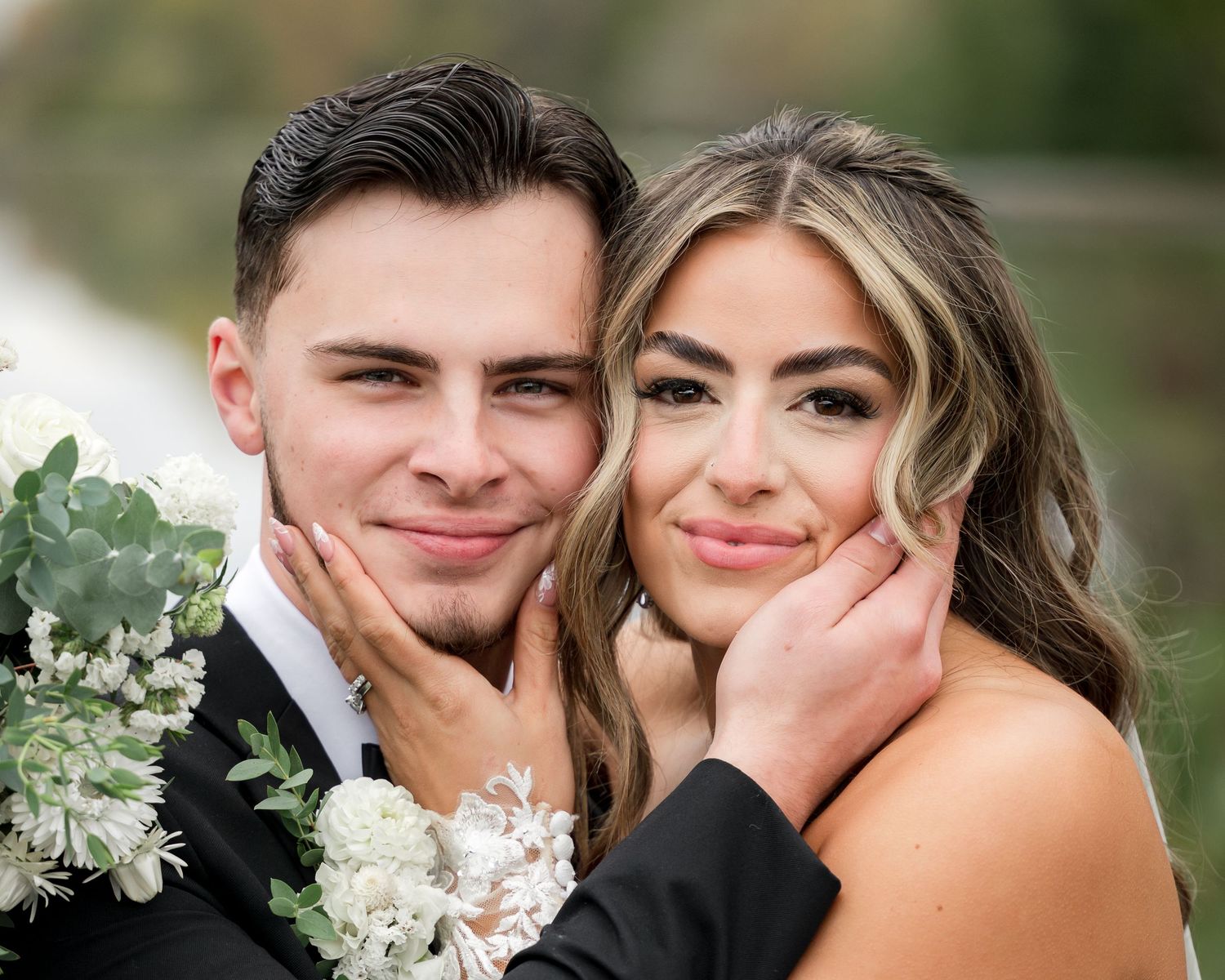 A romantic outdoor photo session featuring a couple with white floral bouquet in a natural setting.