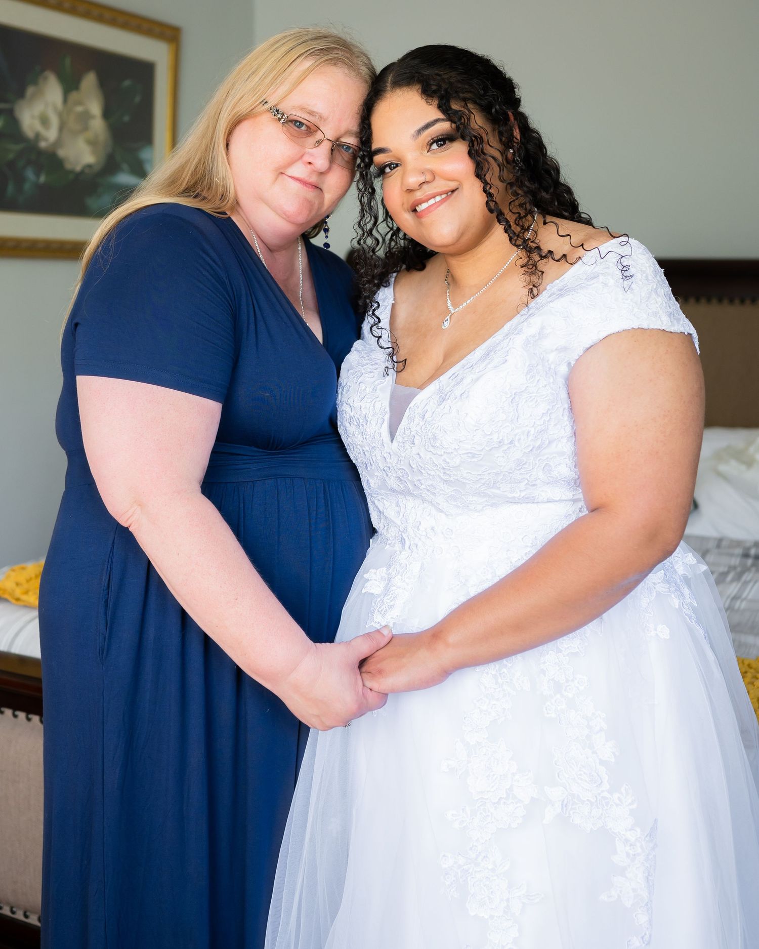 Two people share an intimate moment while wearing formal attire in a bedroom setting.