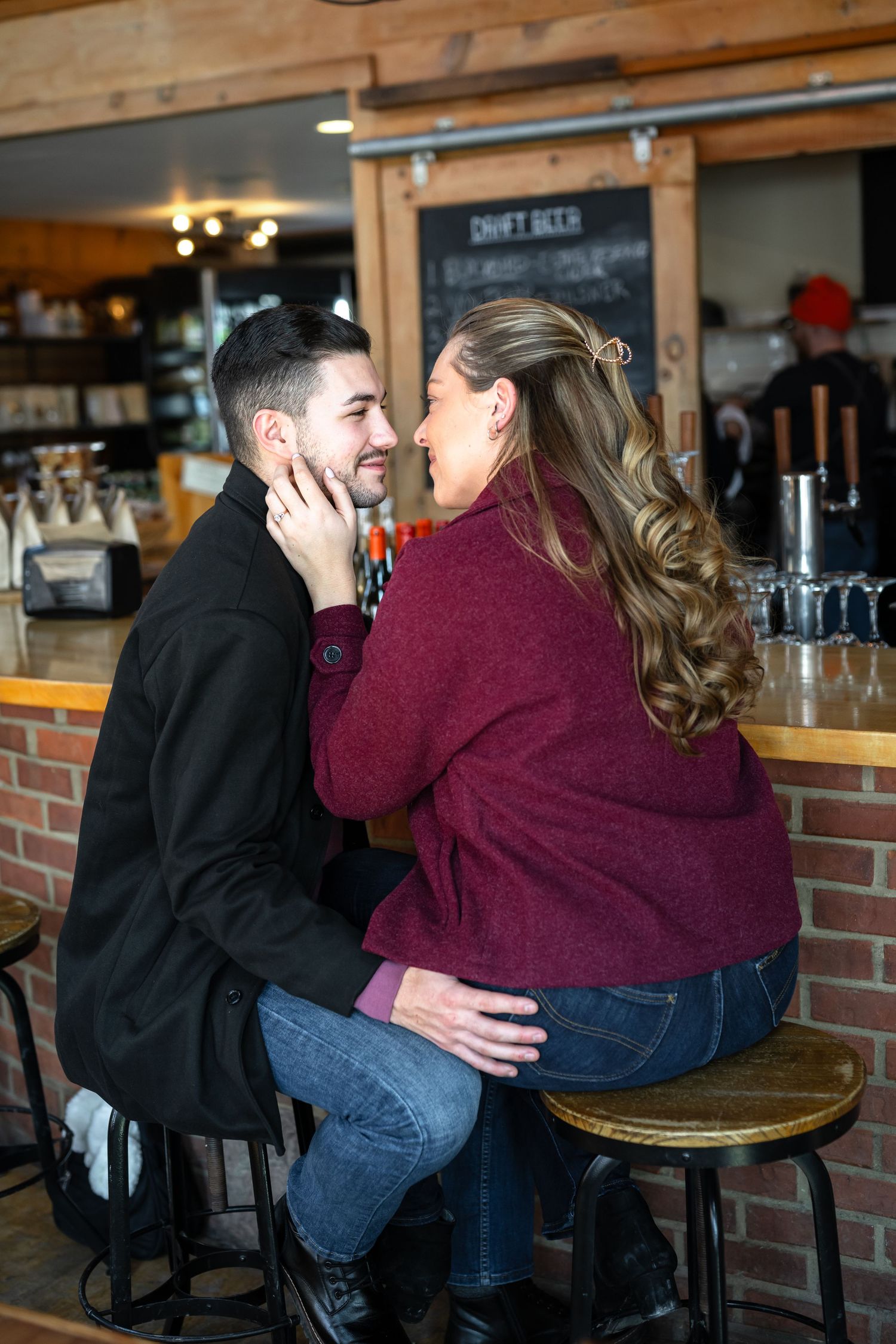 Happy couple sharing romantic moment at a rustic brewery bar together.