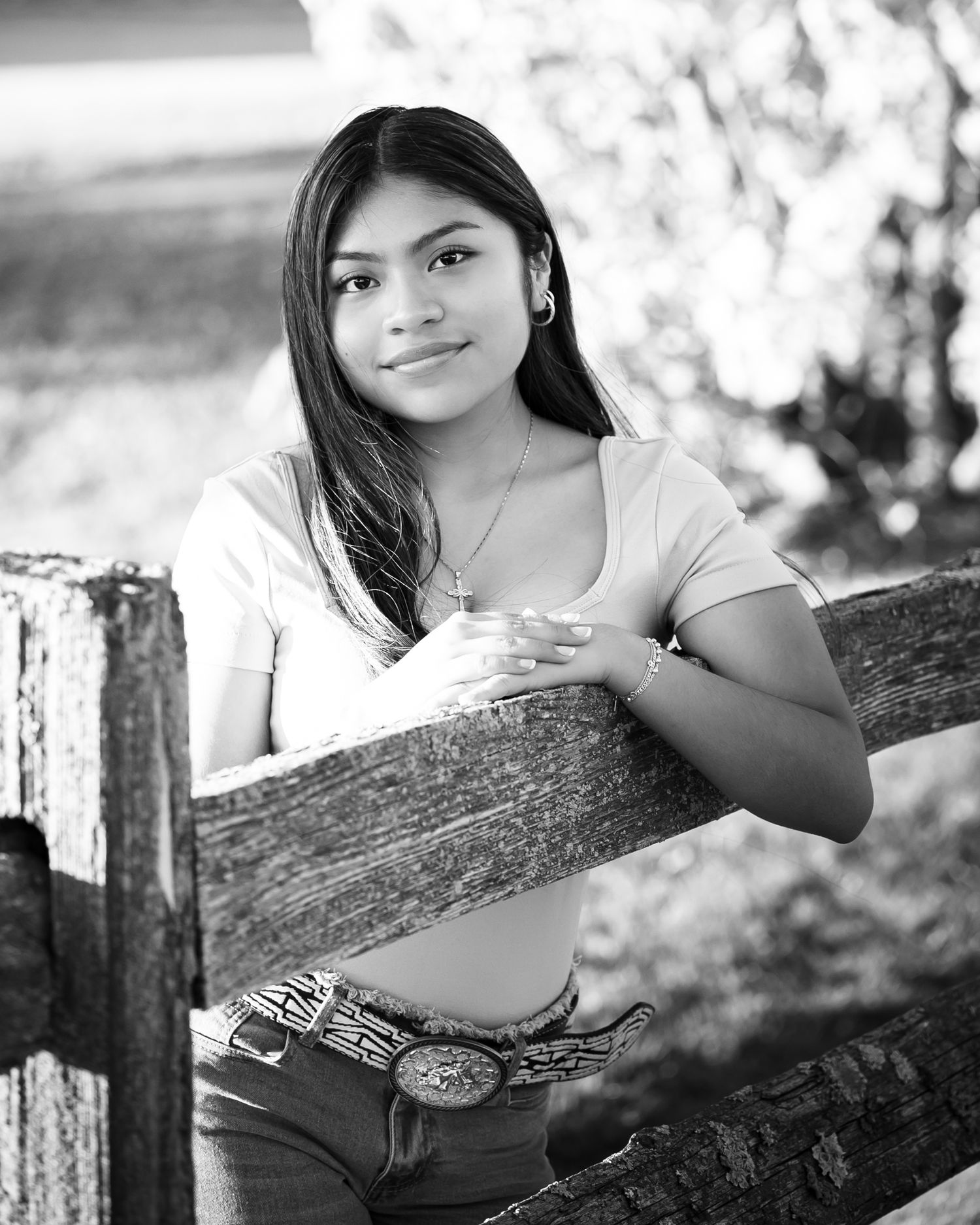 Black and white portrait series showing a person leaning on a rustic wooden fence in an outdoor setting.