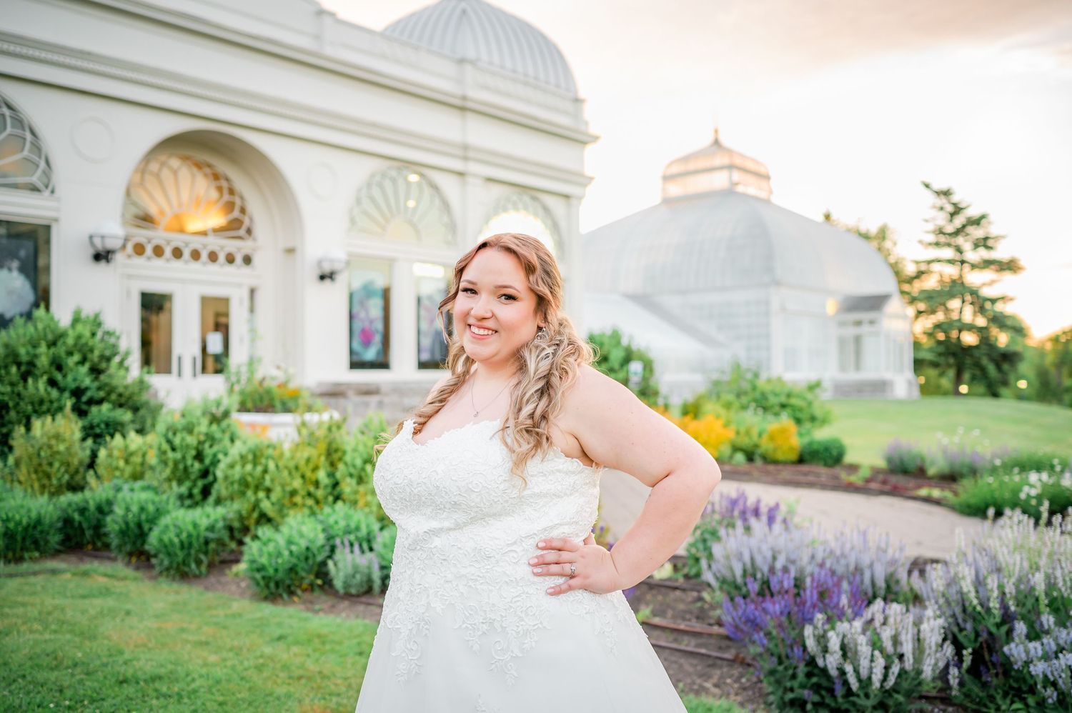Elegant bridal portrait in front of a domed building with lavender garden.