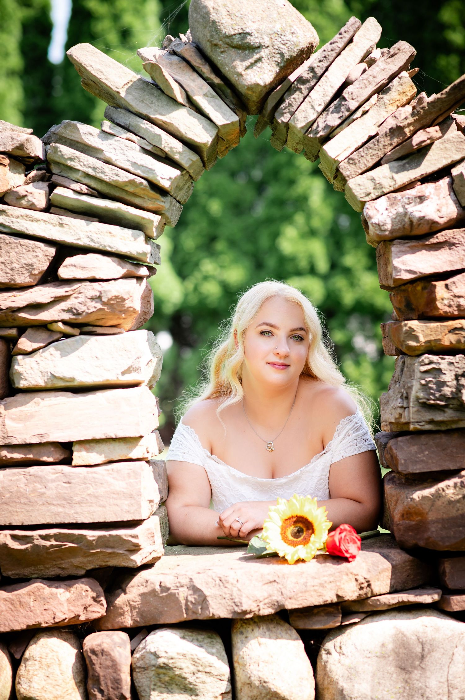 Sunflower adds a pop of color against a handcrafted stone garden arch.