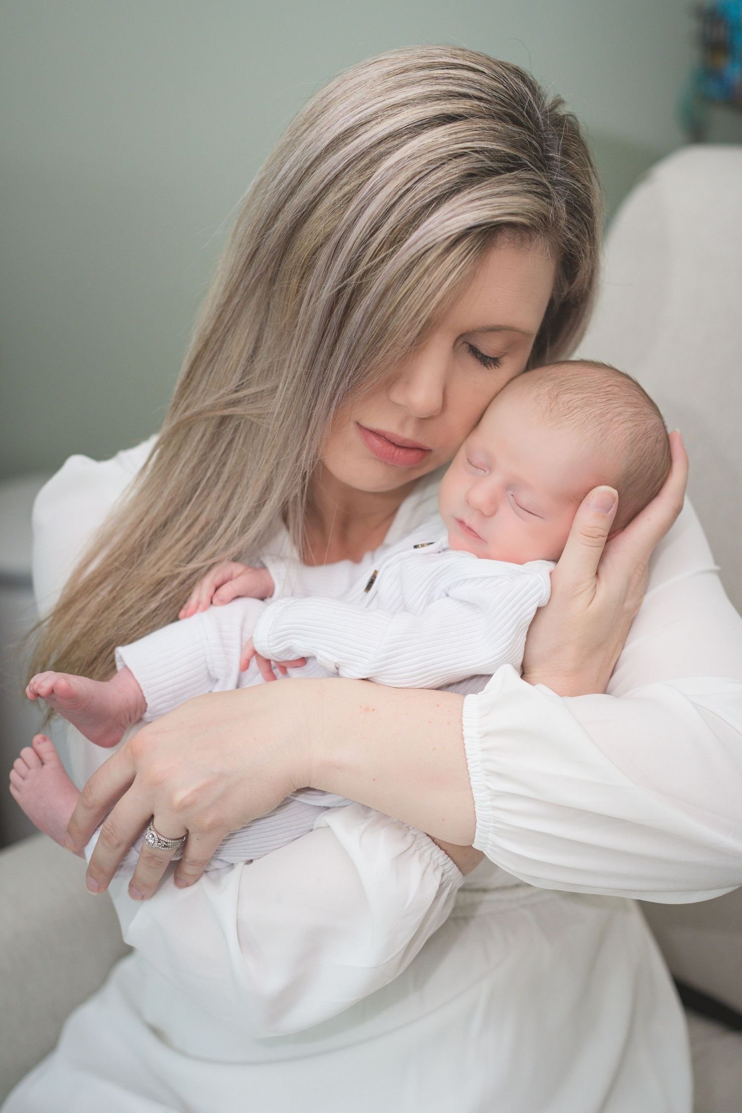 A tender moment between parent and baby captured in a series of intimate black and white portraits.
