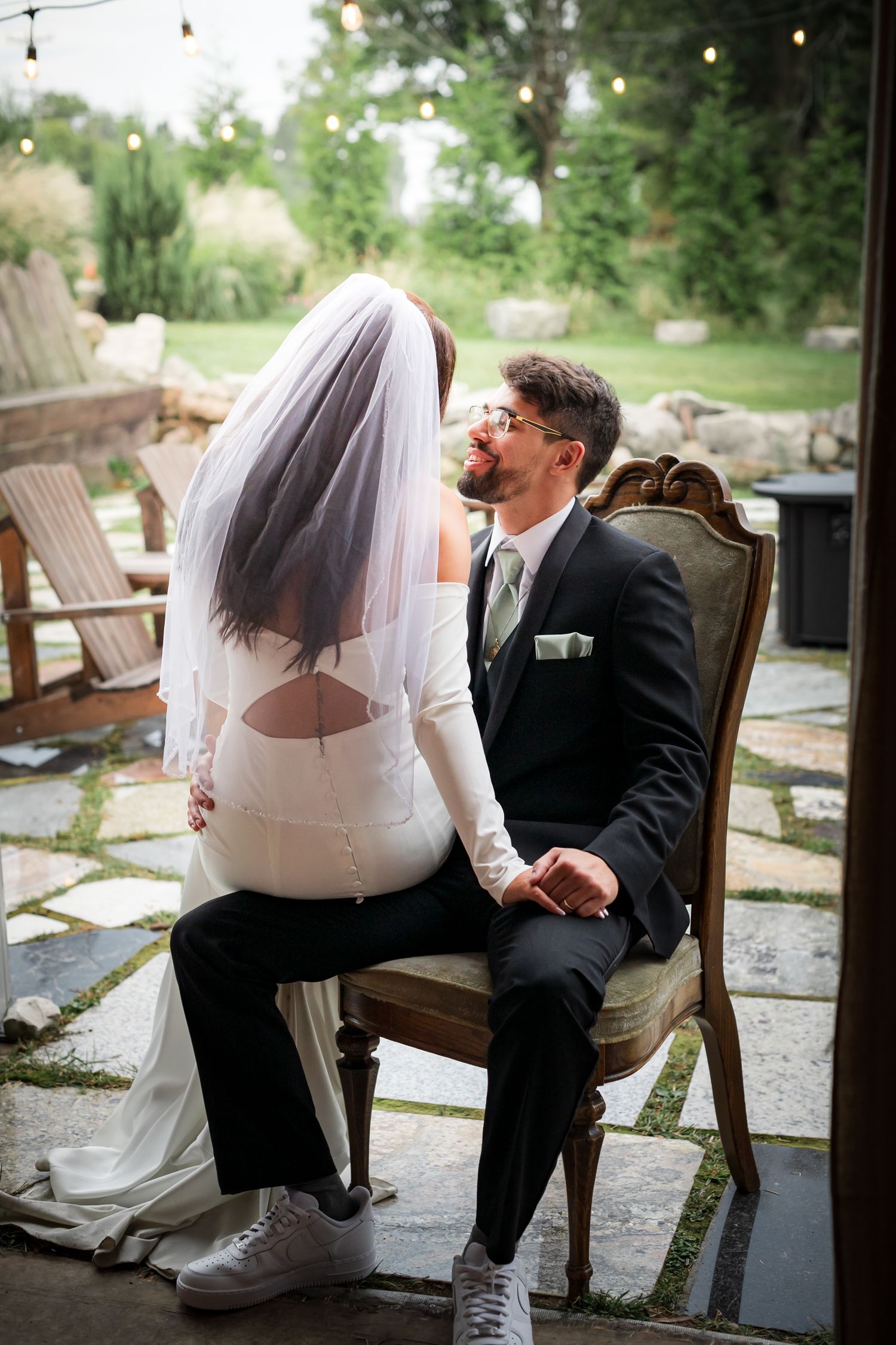A series of romantic wedding photos showing a couple sitting together in chairs on a stone patio.