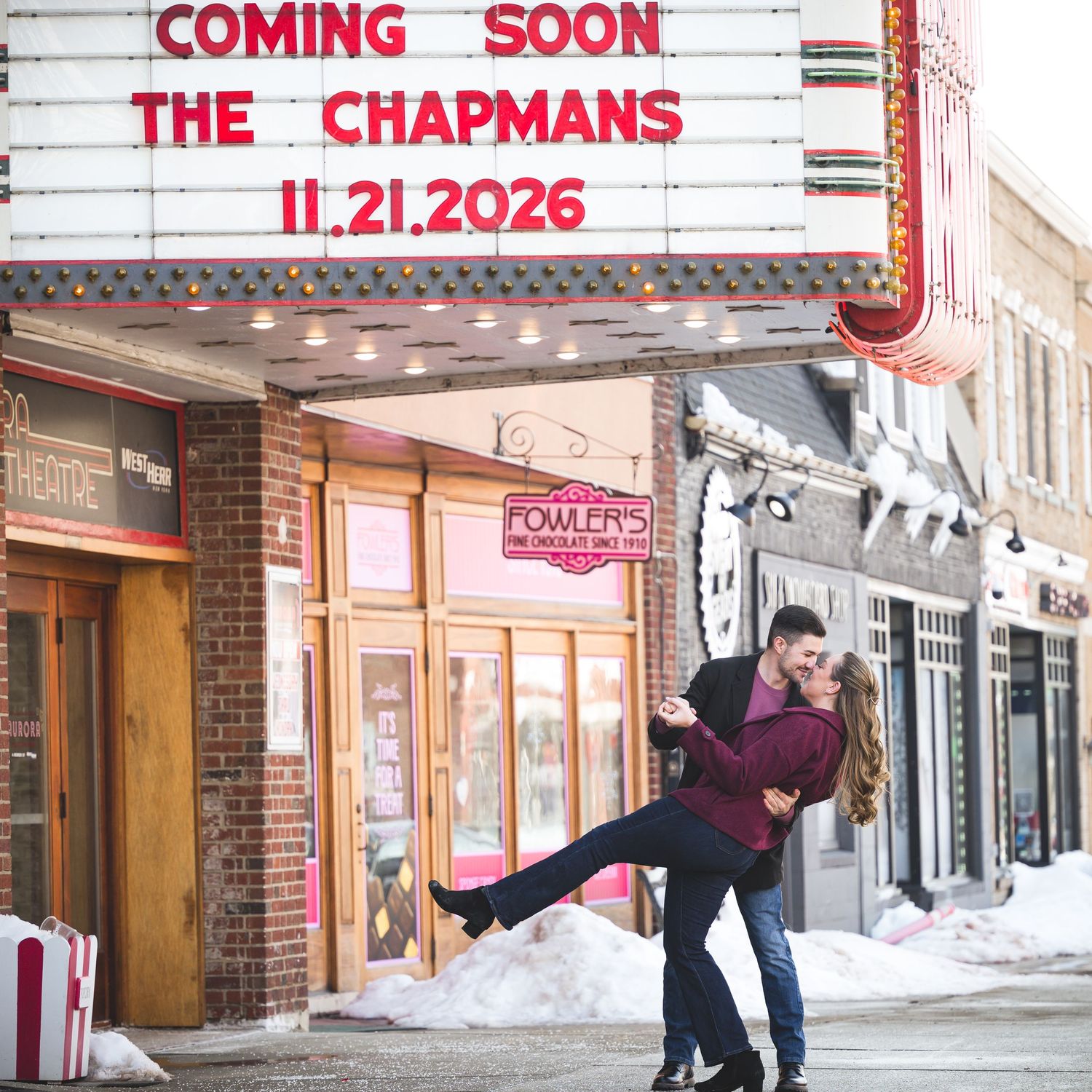 Movie theater marquee displays 'Coming Soon The Chapmans 11.27.2023' on a classic red lettering sign.