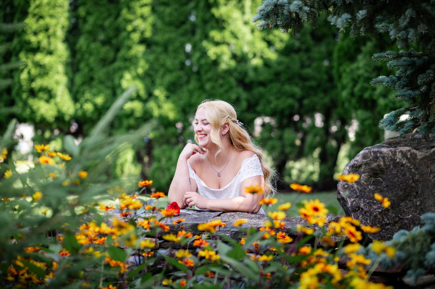 Cheerful orange and yellow flowers bloom abundantly in a lush summer garden setting.