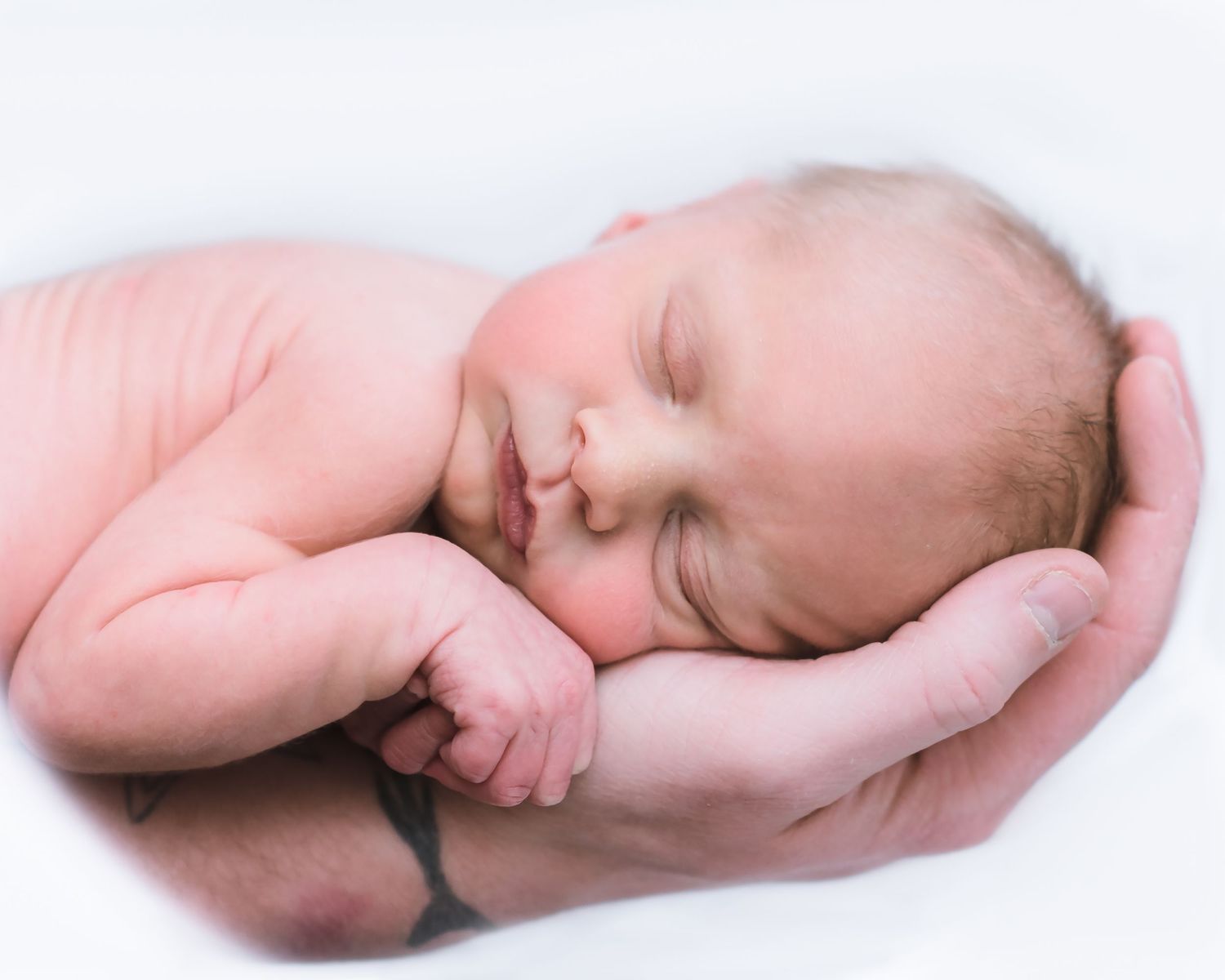 A sleeping newborn baby lying on white blankets shown from different angles in a collage format.
