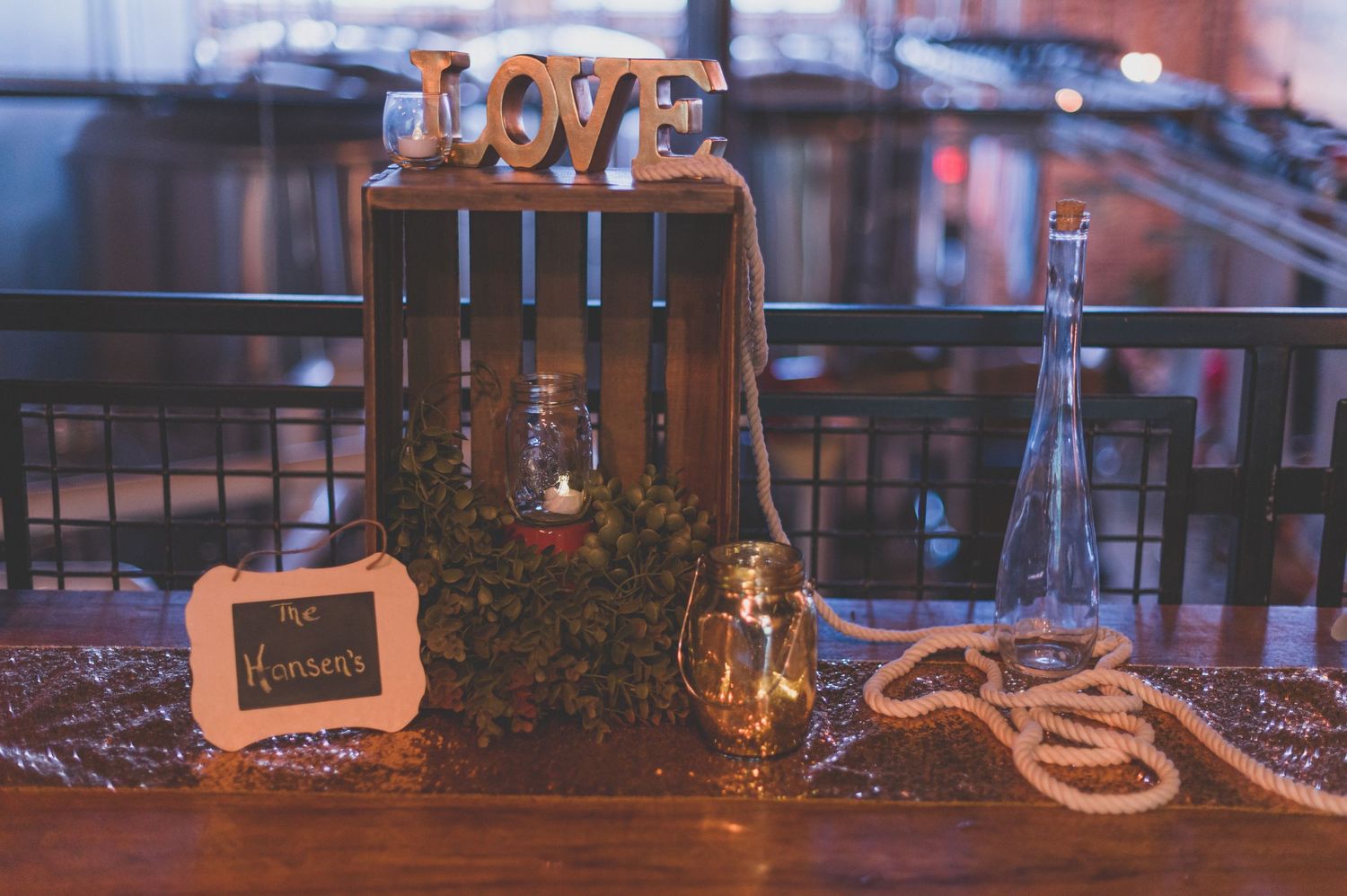 Rustic wedding decor with wooden elements and 'LOVE' lettering on display.