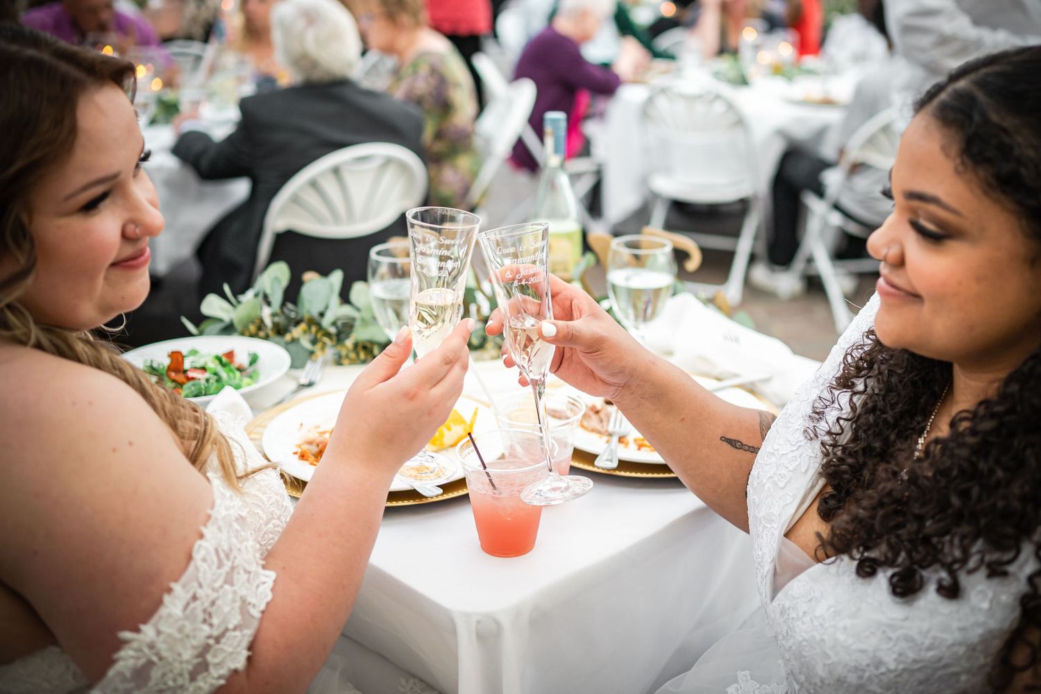 Couple toasting with drinks at their wedding reception dinner.