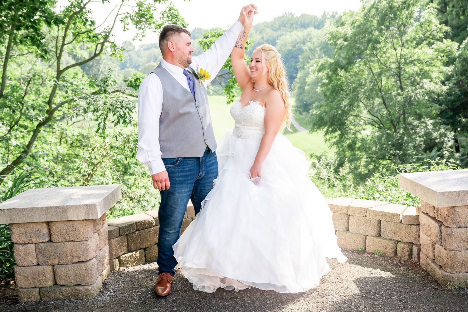A couple sharing a romantic moment on a stone terrace overlooking a scenic landscape.