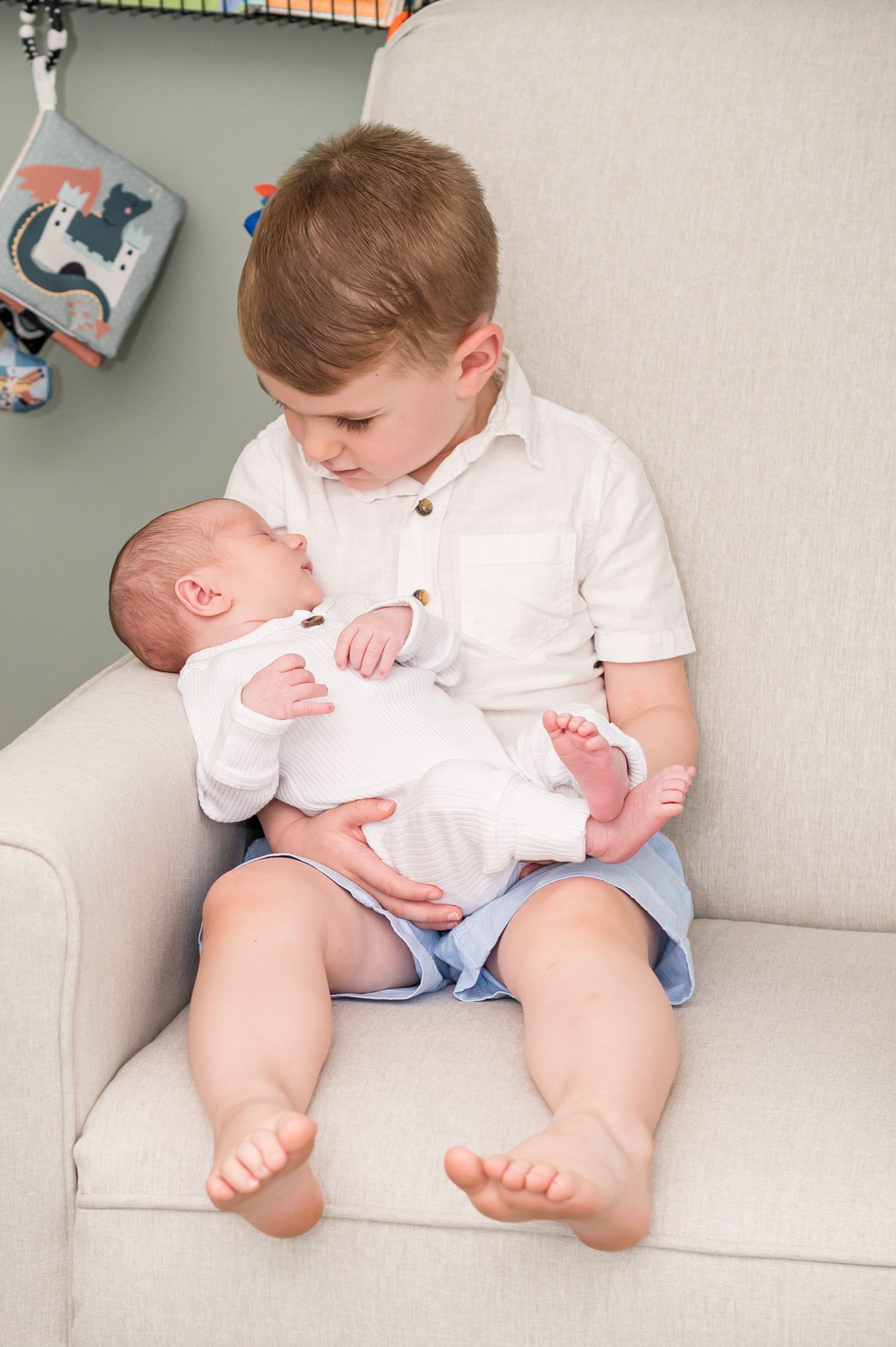 A series of four connected photos showing a young child in white shirt sitting on a light colored couch.
