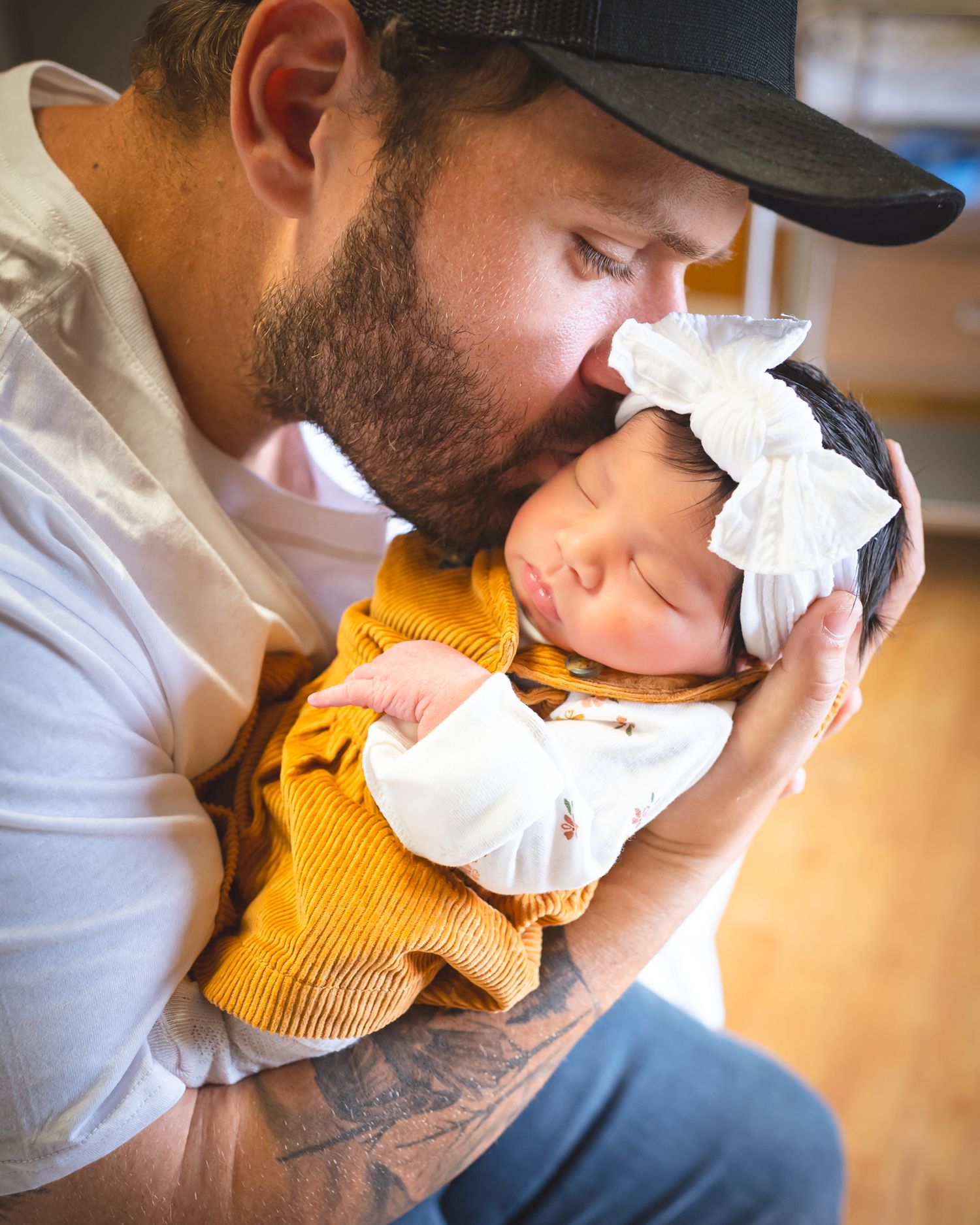 A series of intimate close-up shots showing gentle moments with a baby wearing a yellow knit sweater.