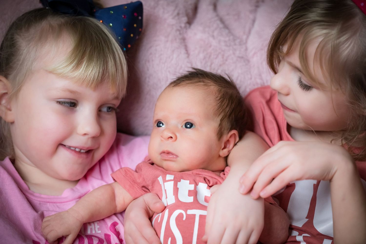 A series of close-up photos showing tender moments between parents and children in soft pink lighting.