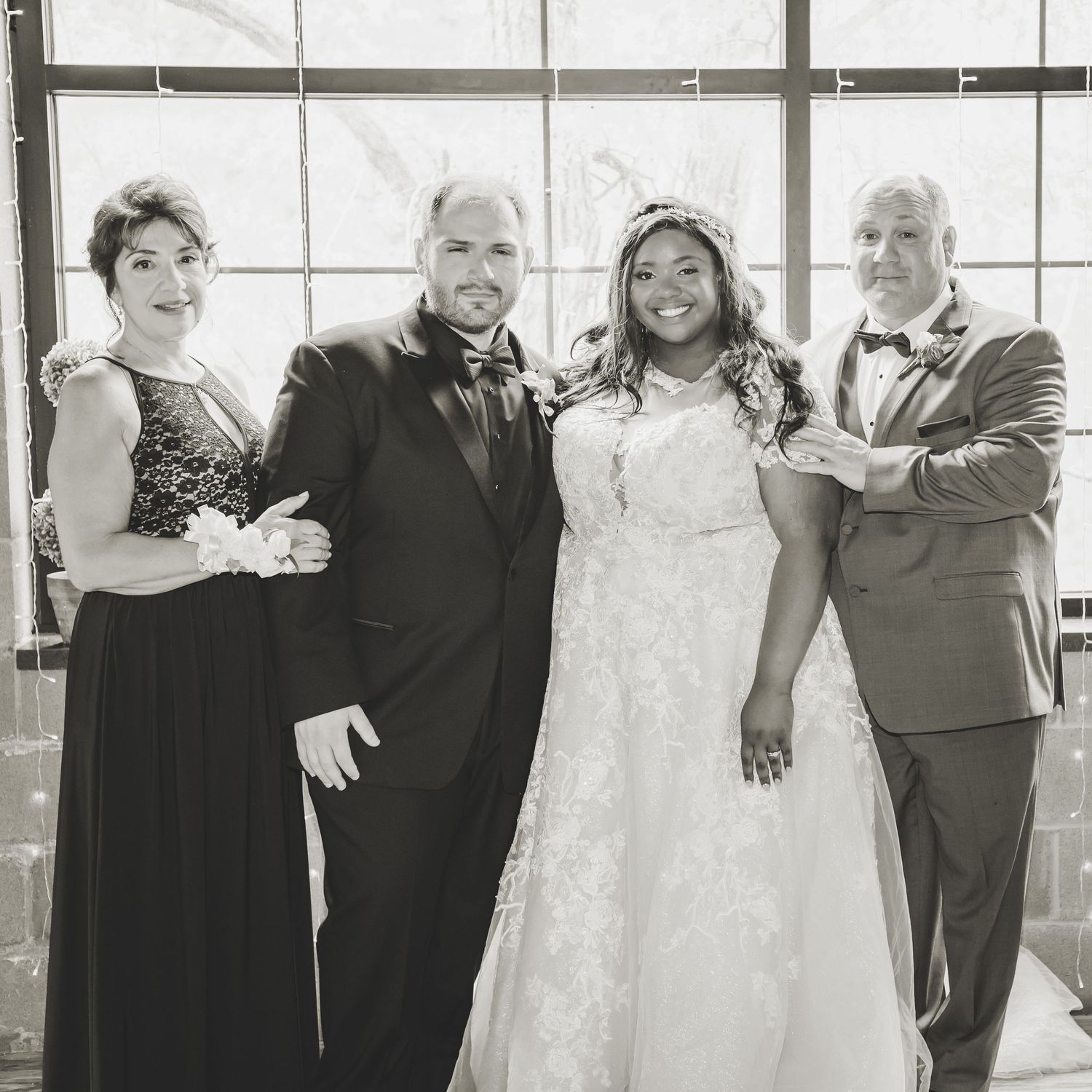 Black and white wedding party portrait with bride, groom and wedding party members.