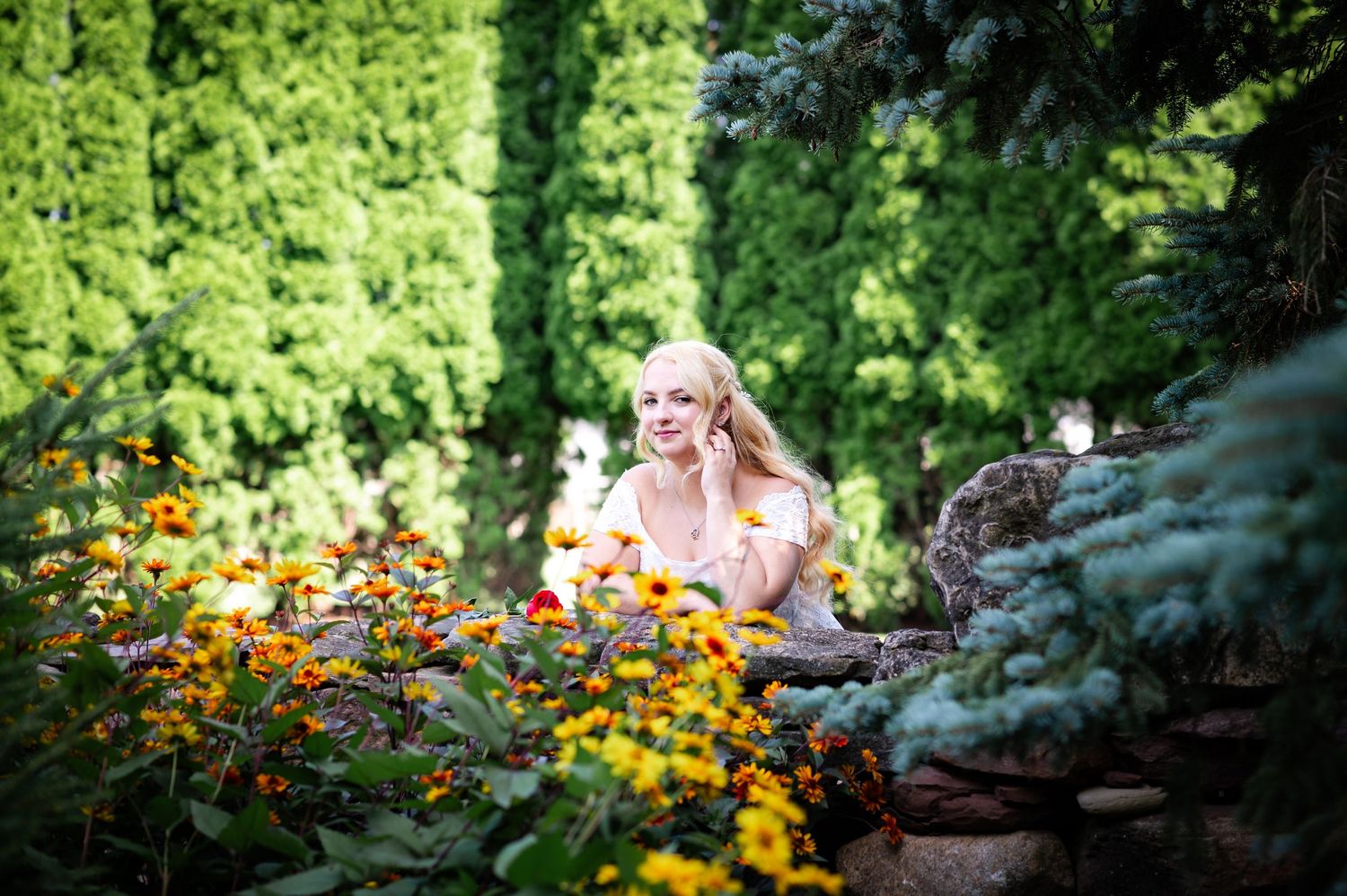 A romantic garden portrait surrounded by vibrant orange and yellow flowers.