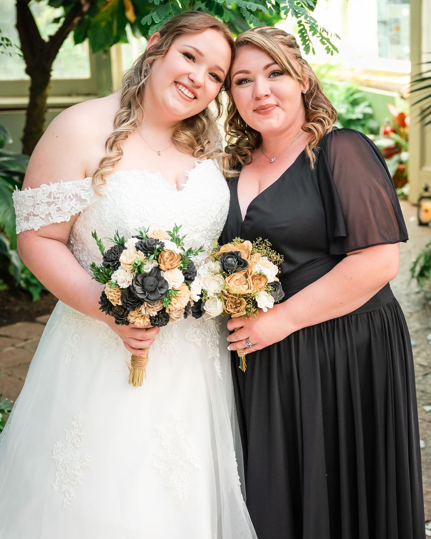 A wedding portrait features coordinating floral bouquets against a lush garden backdrop.