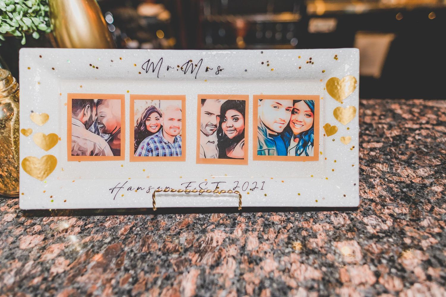 A decorative photo frame displaying four romantic couple photos with golden heart details.