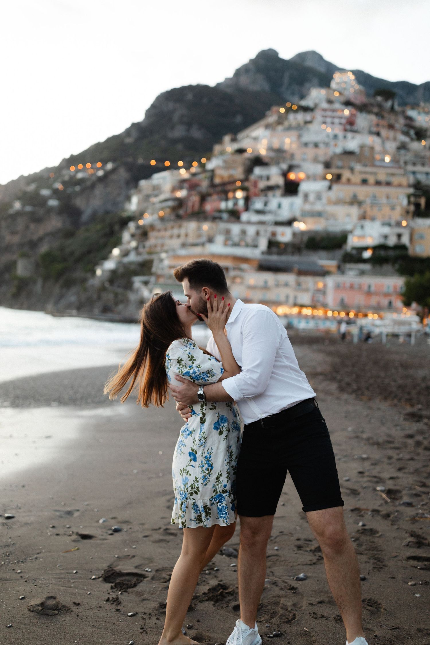 Couple kissing at the beach in Positano Italy during blue hour