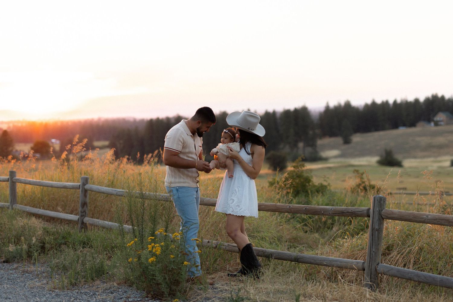family hanging out in a countryside location during sunset