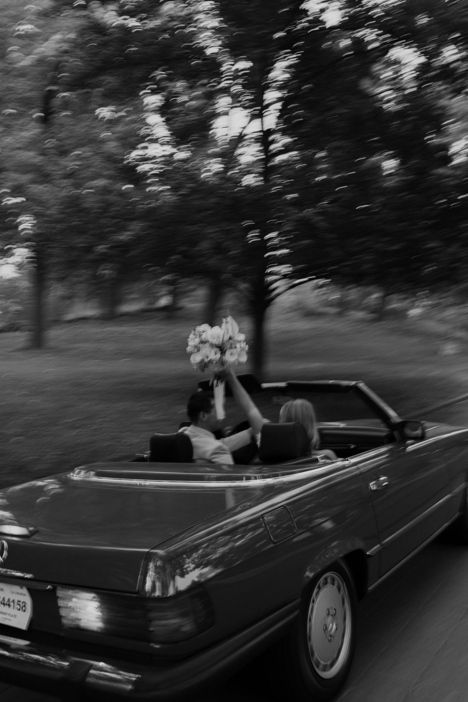 slow shutter captured a couple in a classic Mercedes getaway car driving off