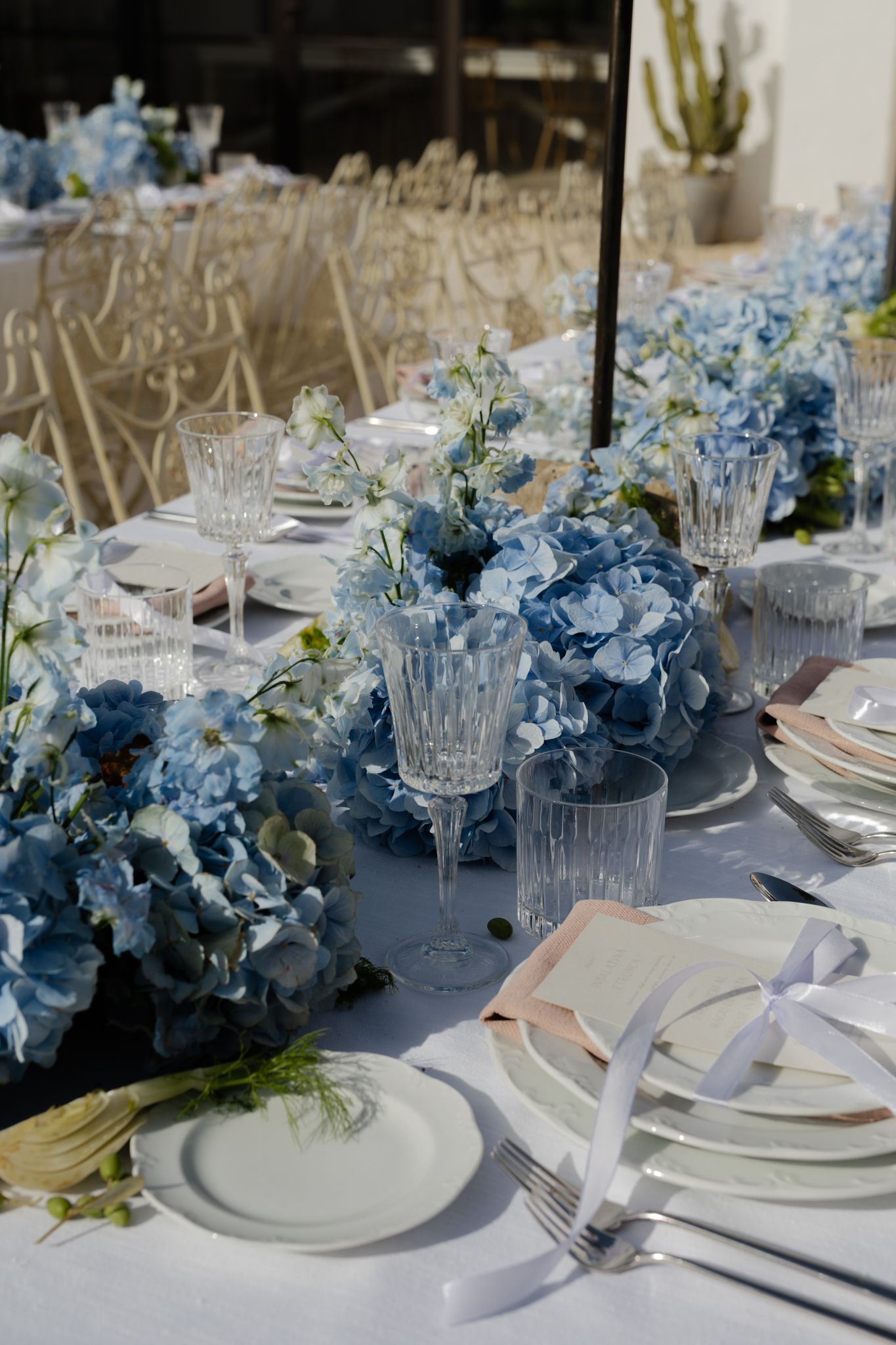 delicate pastel wedding table scape with Blue hydrangea arrangements